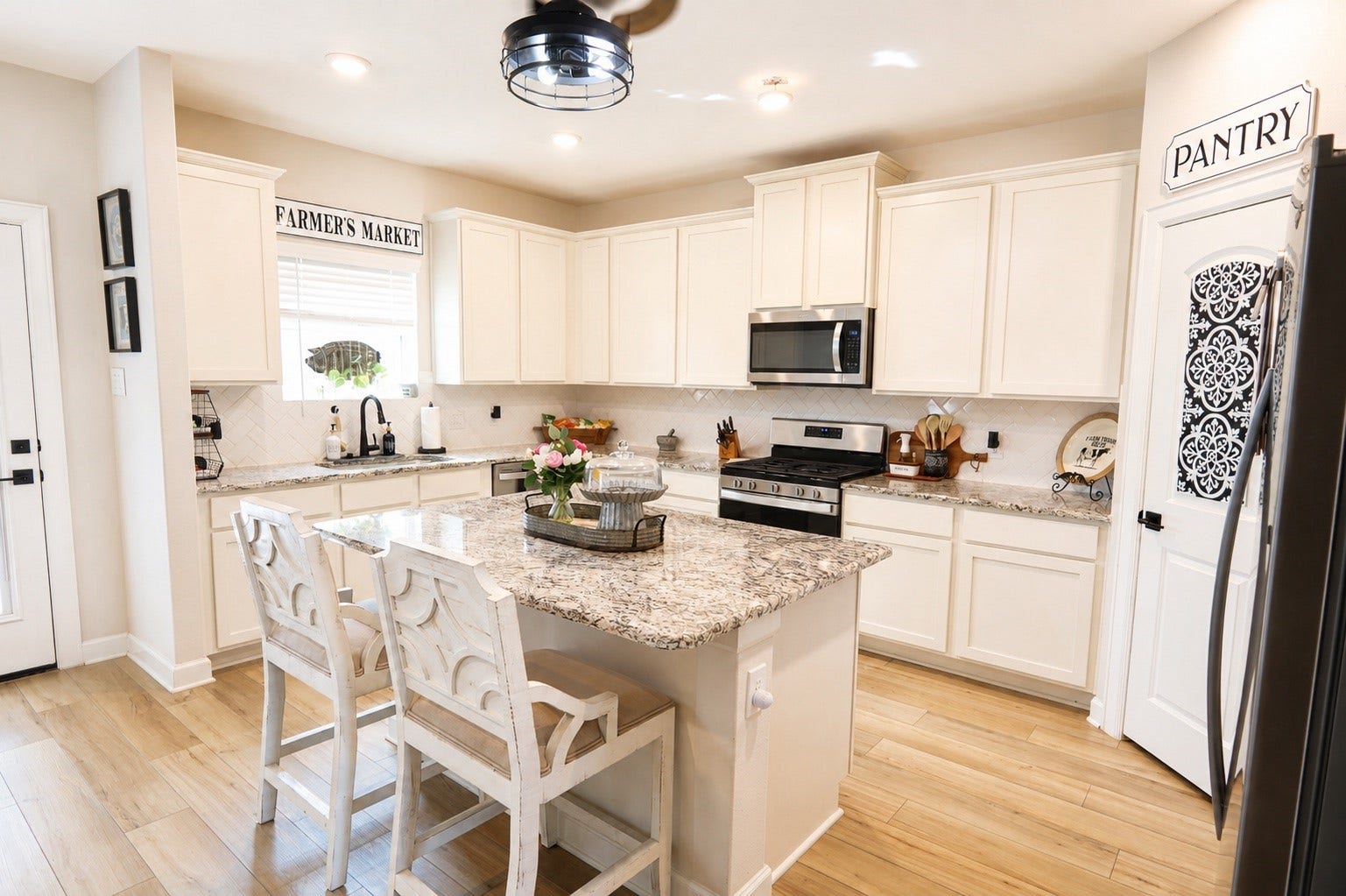 837 Dawn Redwood Court, Conroe, TX 77304 Bright, inviting kitchen featuring elegant granite countertops, modern stainless steel appliances, and ample cabinet space, complemented by warm laminate flooring and charming farmhouse accents.