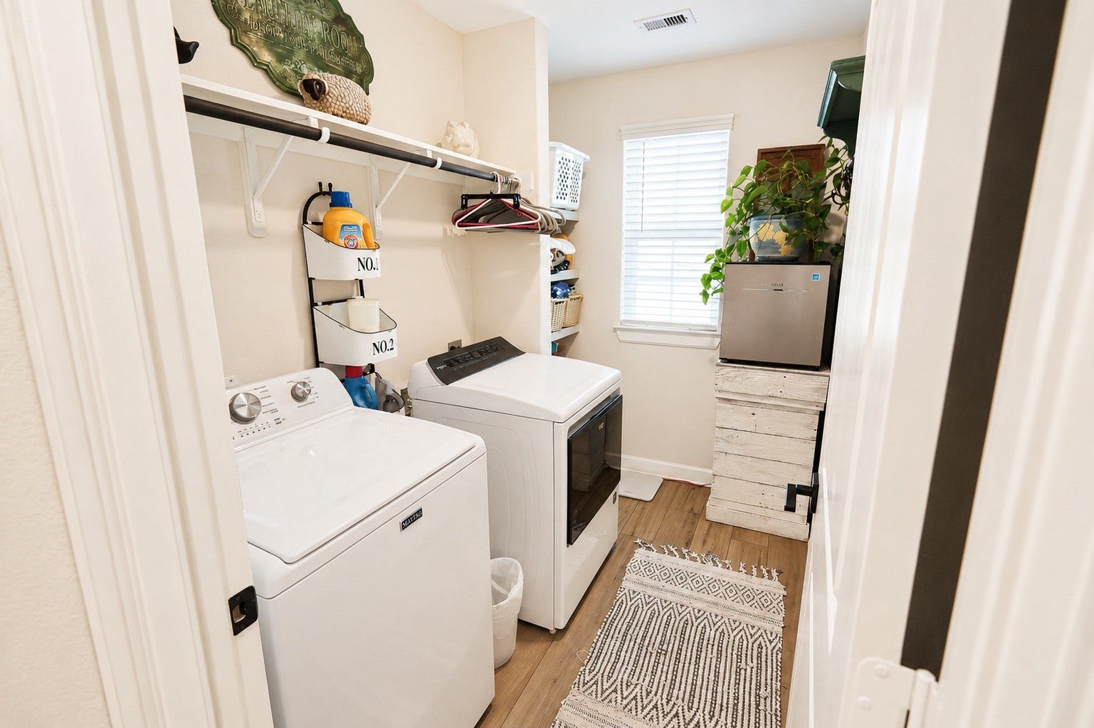 837 Dawn Redwood Court, Conroe, TX 77304 Bright and efficient laundry room featuring ample shelving, and natural light from a large window.