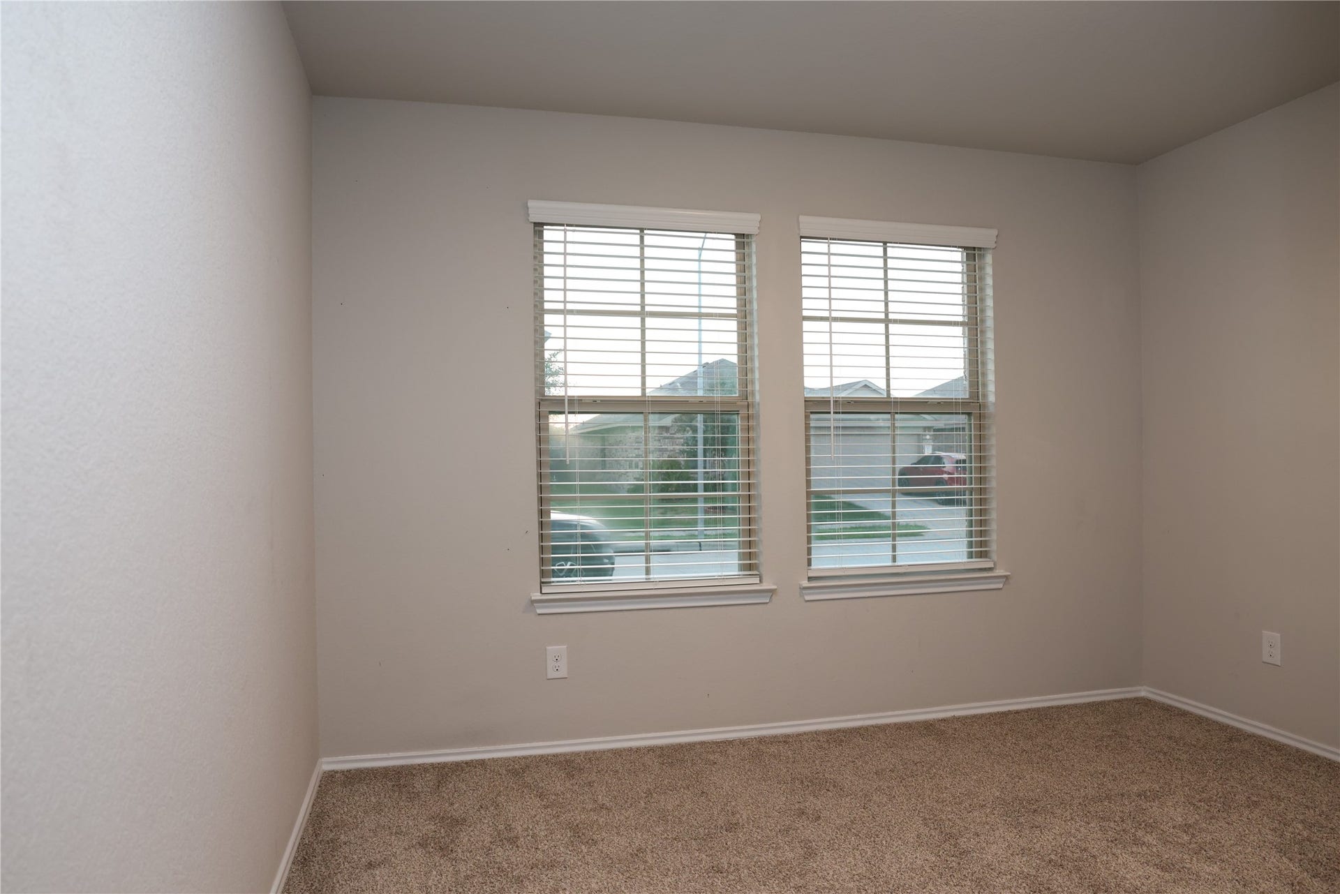 4th bedroom Bright and cozy room featuring dual windows with blinds