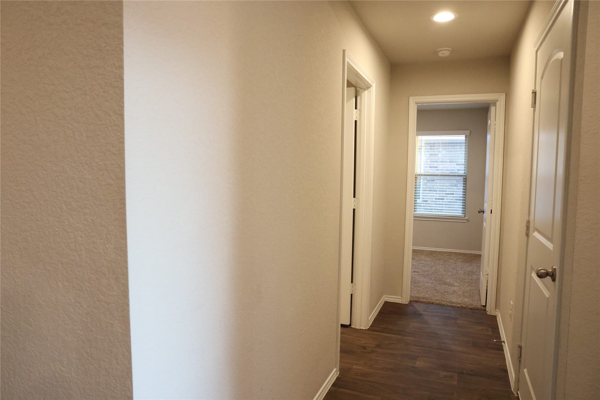 Bright hallway with polished hardwood floors
