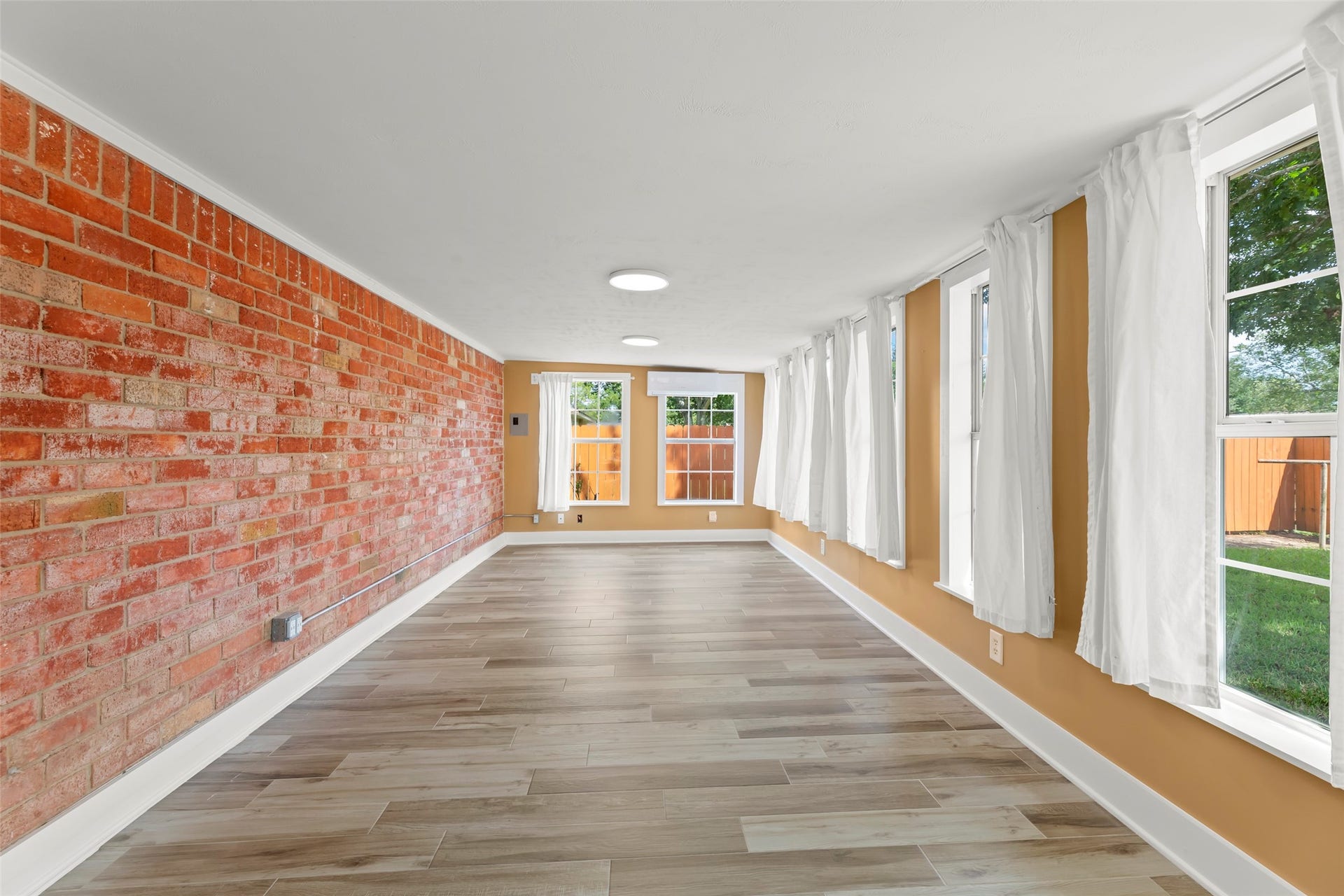 3419 Beasley Avenue, Needville, TX 77461 Brick accent wall in sunroom