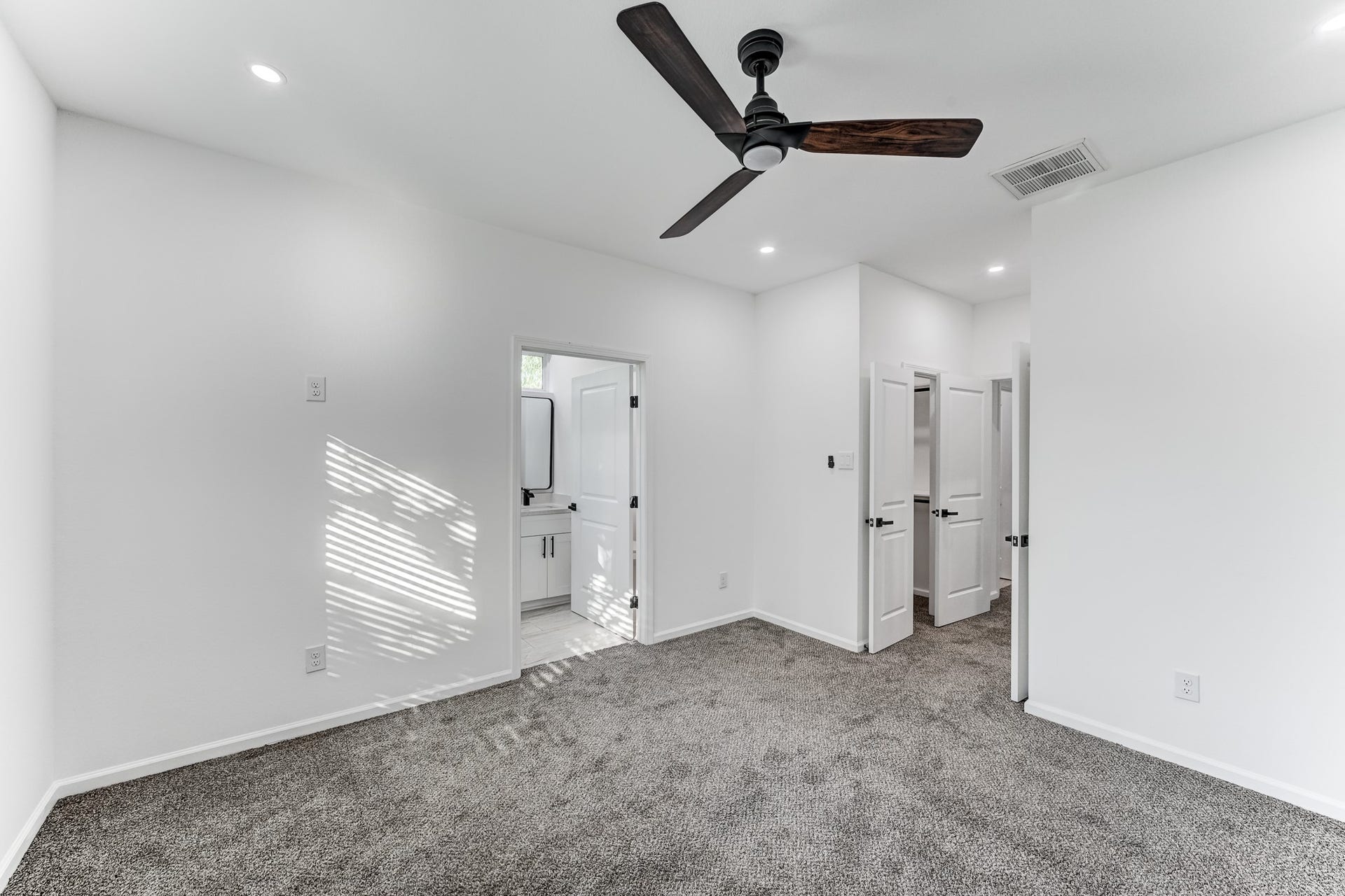Primary bedroom with ceiling fan