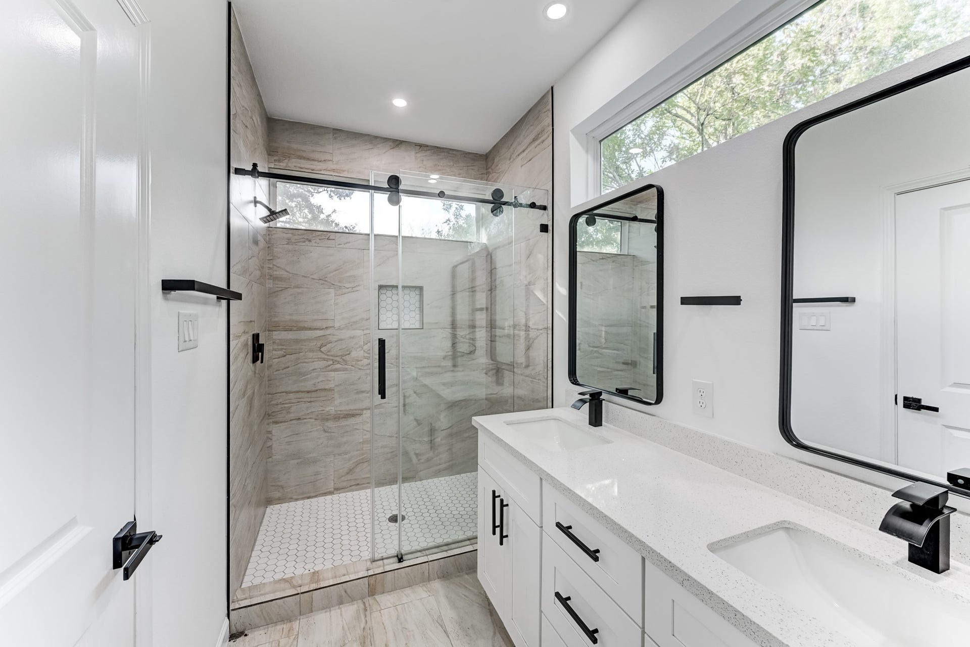 Primary bathroom with glass enclosed shower