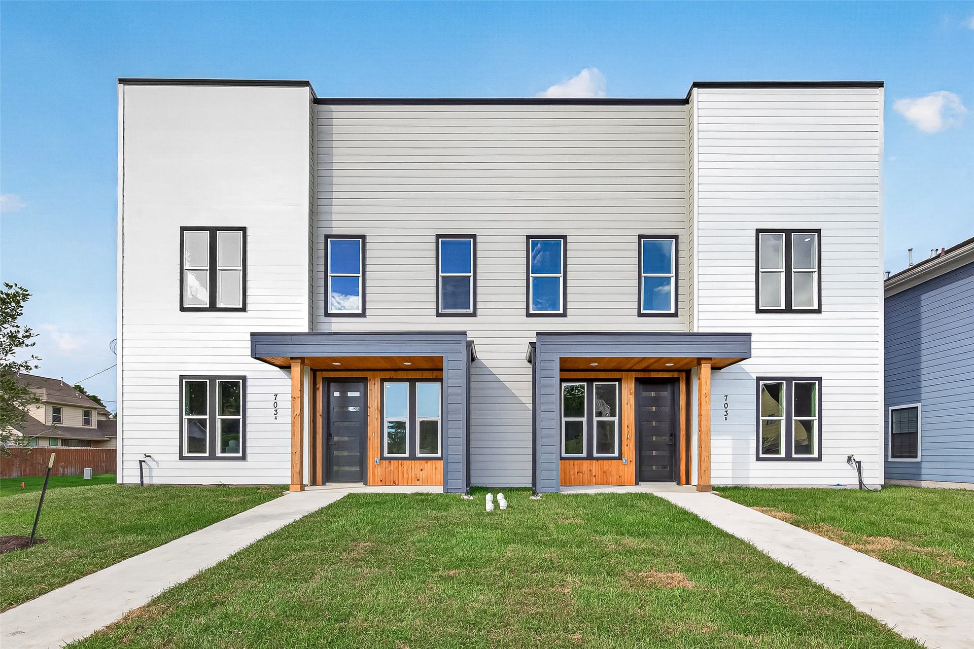 Modern new construction duplex with upscale curb appeal.