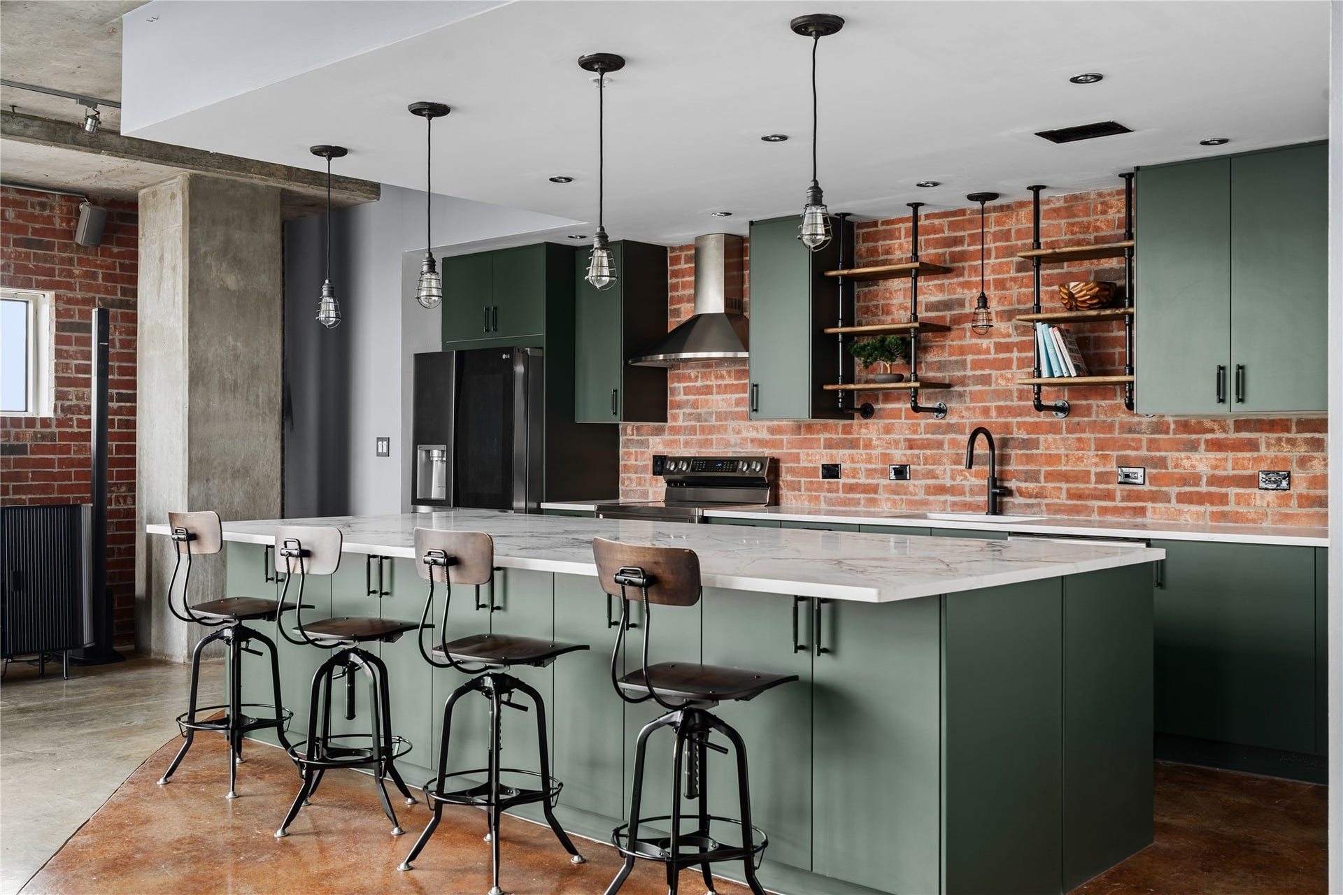 2000 Bagby St Street, #13430, Houston, TX 77002 The completely renovated kitchen becomes a striking centerpiece of the loft, pairing custom cabinetry, an oversized island and modern finishes with the warmth of the original exposed brick backdrop.