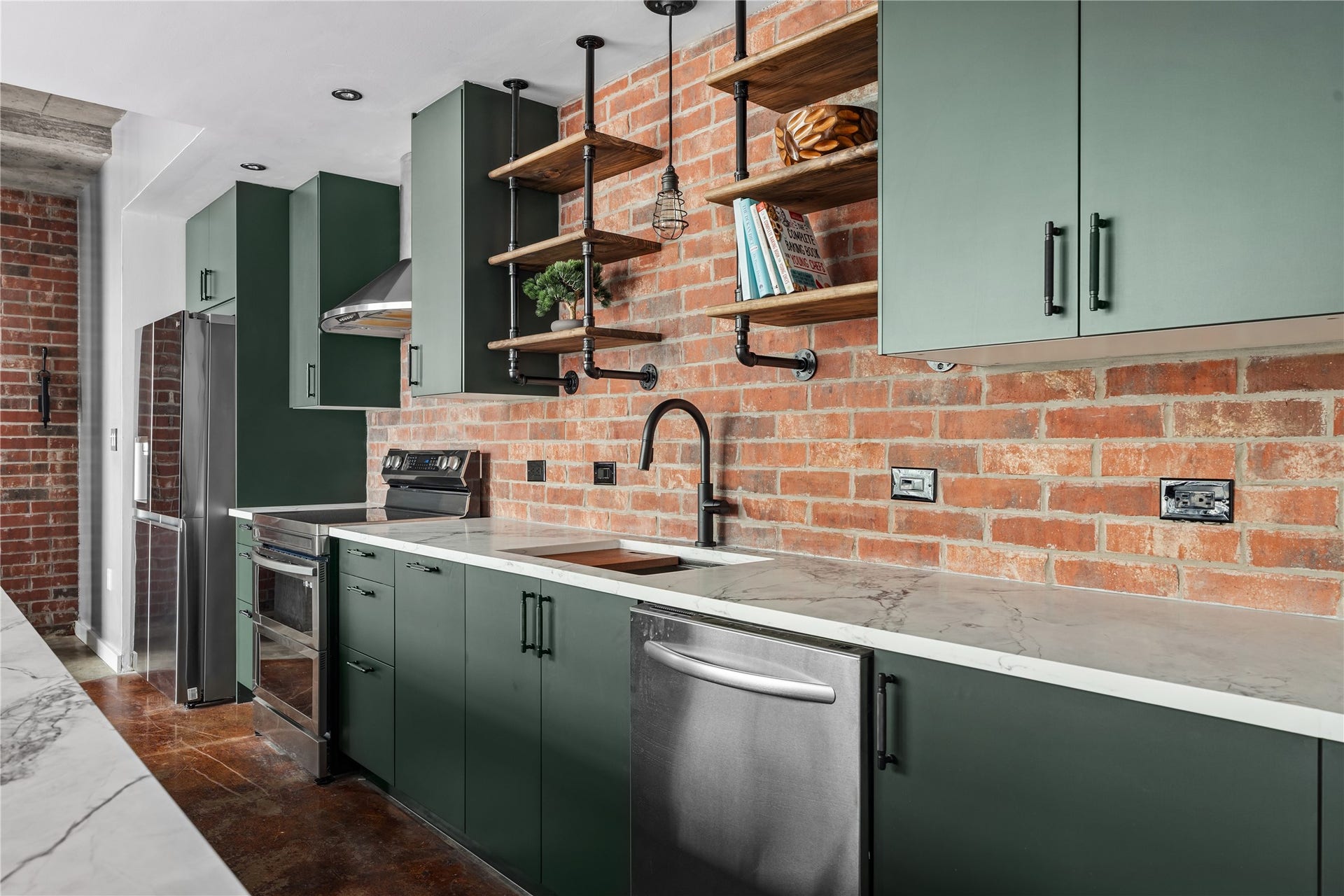 2000 Bagby St Street, #13430, Houston, TX 77002 A closer view highlights the kitchens thoughtful renovation, where rich cabinetry and modern appliances are set against exposed brick for a refined take on authentic loft living.