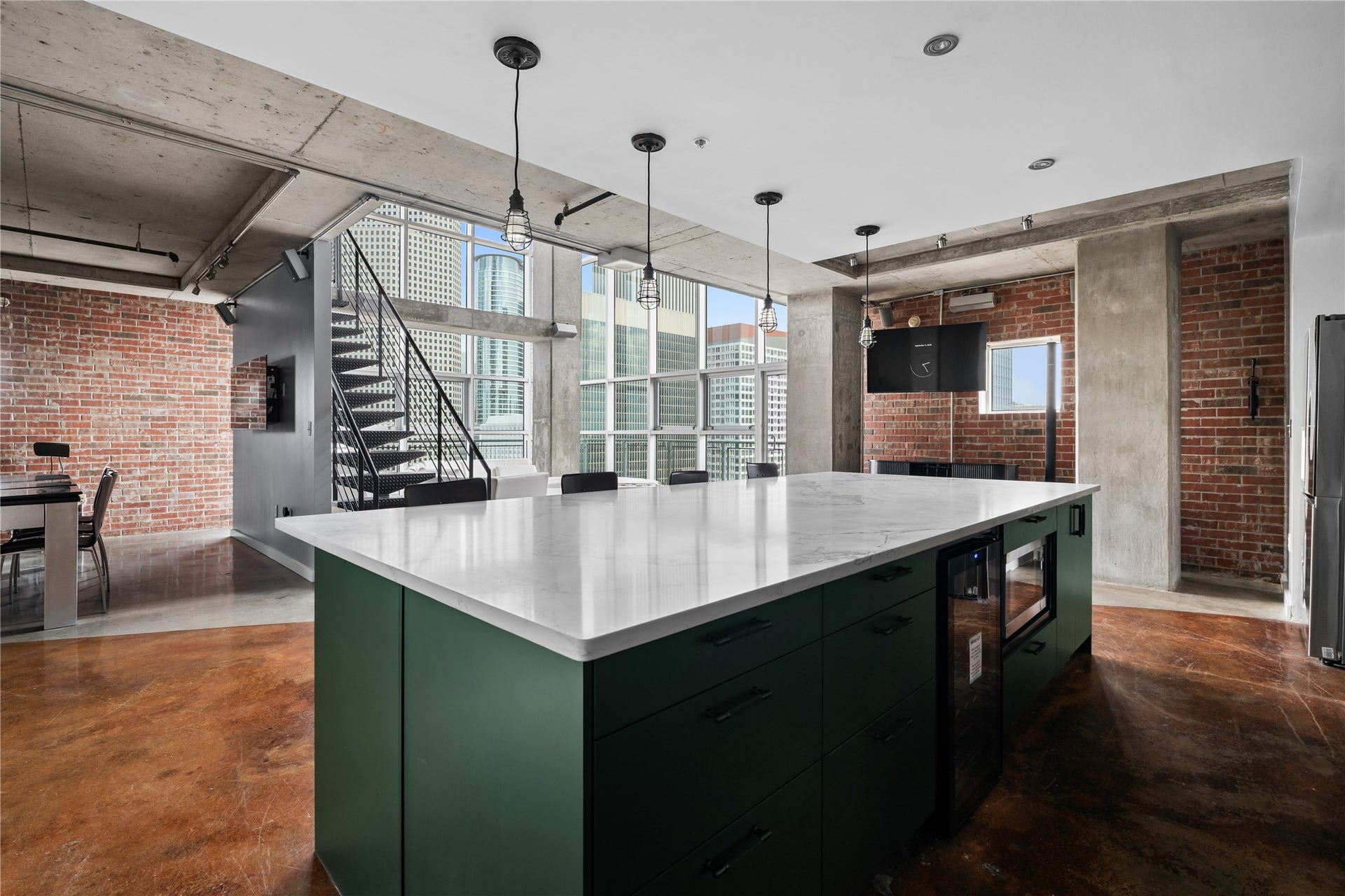 2000 Bagby St Street, #13430, Houston, TX 77002 The oversized island anchors the kitchen while maintaining an open connection to the lofts dramatic two story living space and signature industrial architecture.