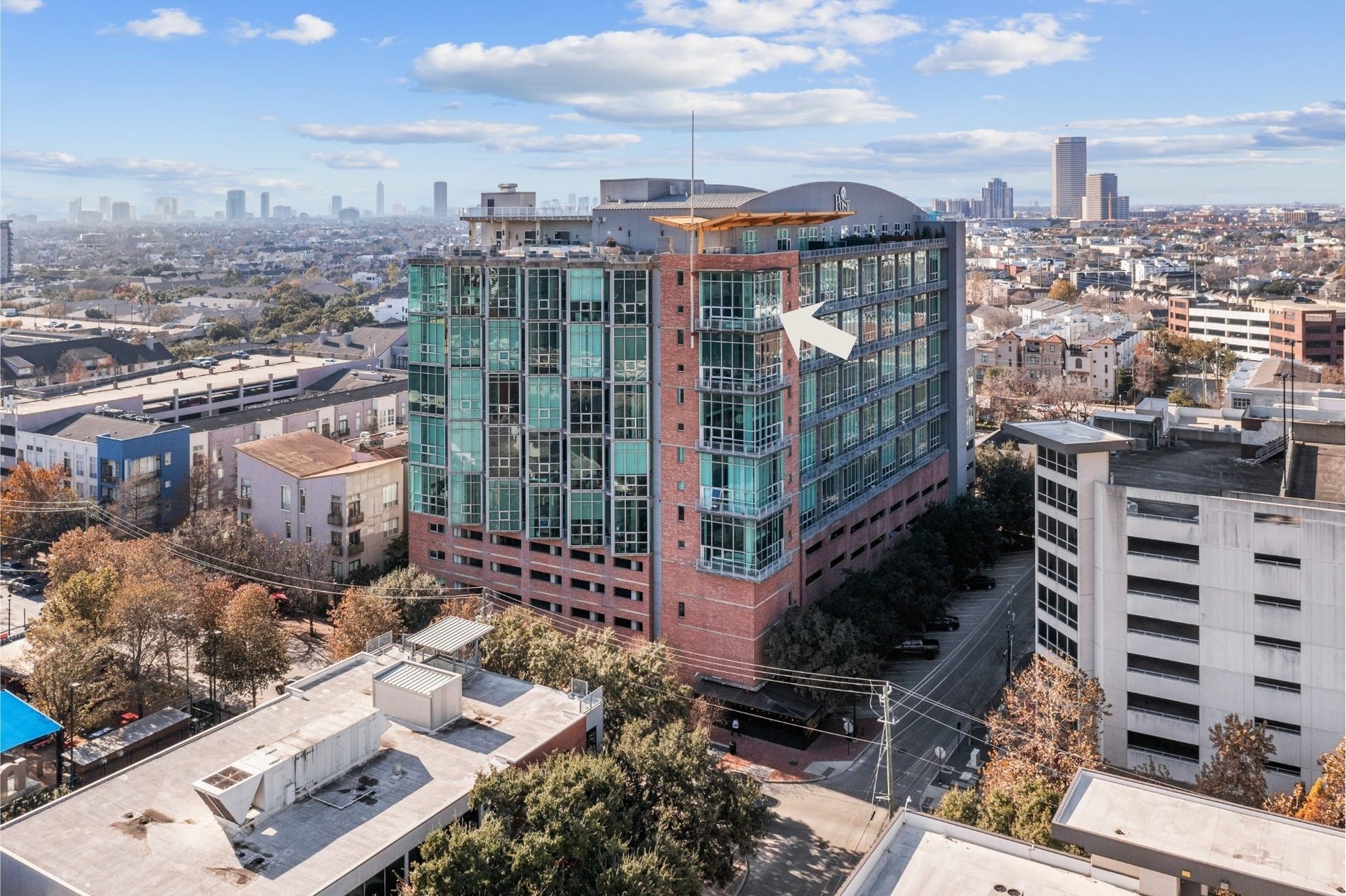 2000 Bagby St Street, #13430, Houston, TX 77002 Aerial view of Rise Lofts, showcasing its distinctive architecture and prominent setting in the heart of Midtown, surrounded by Houstons urban landscape.The only active condo in the development with a penthouse feel.