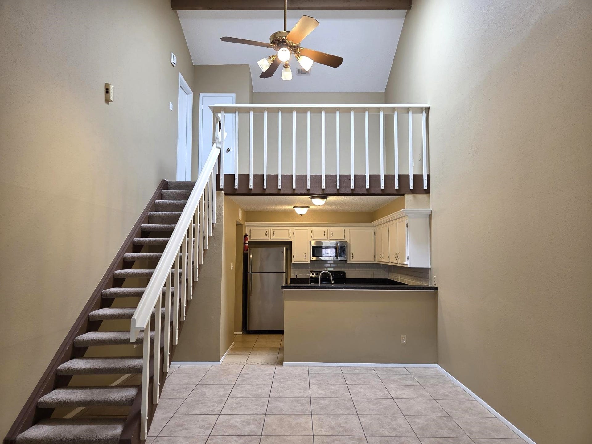 View of Staircase, dining area and kitchen.