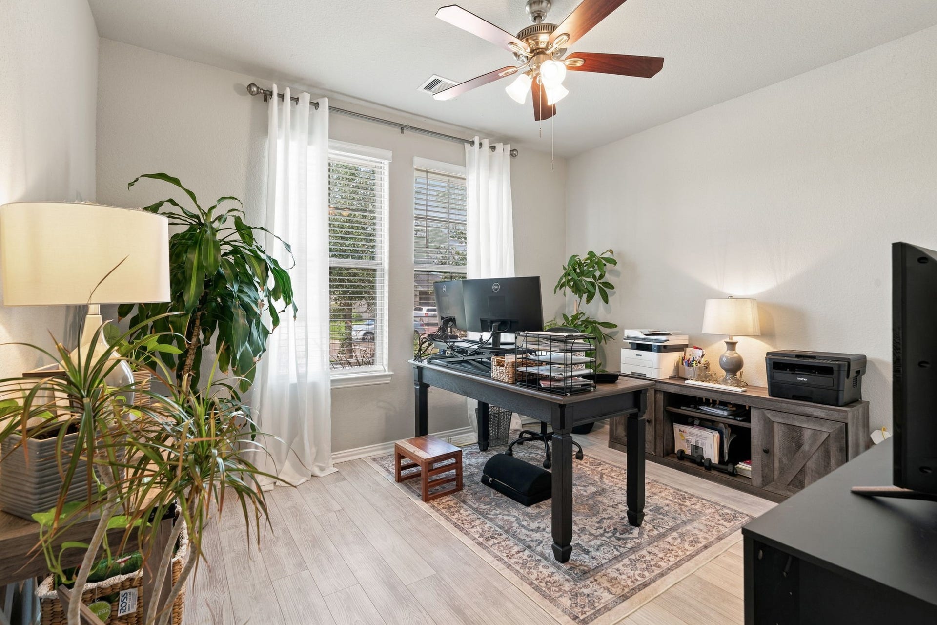31410 Whitfield Court, Fulshear, TX 77441 Home office with ample natural light, modern ceiling fan, and stylish decor, perfect for productivity and comfort.