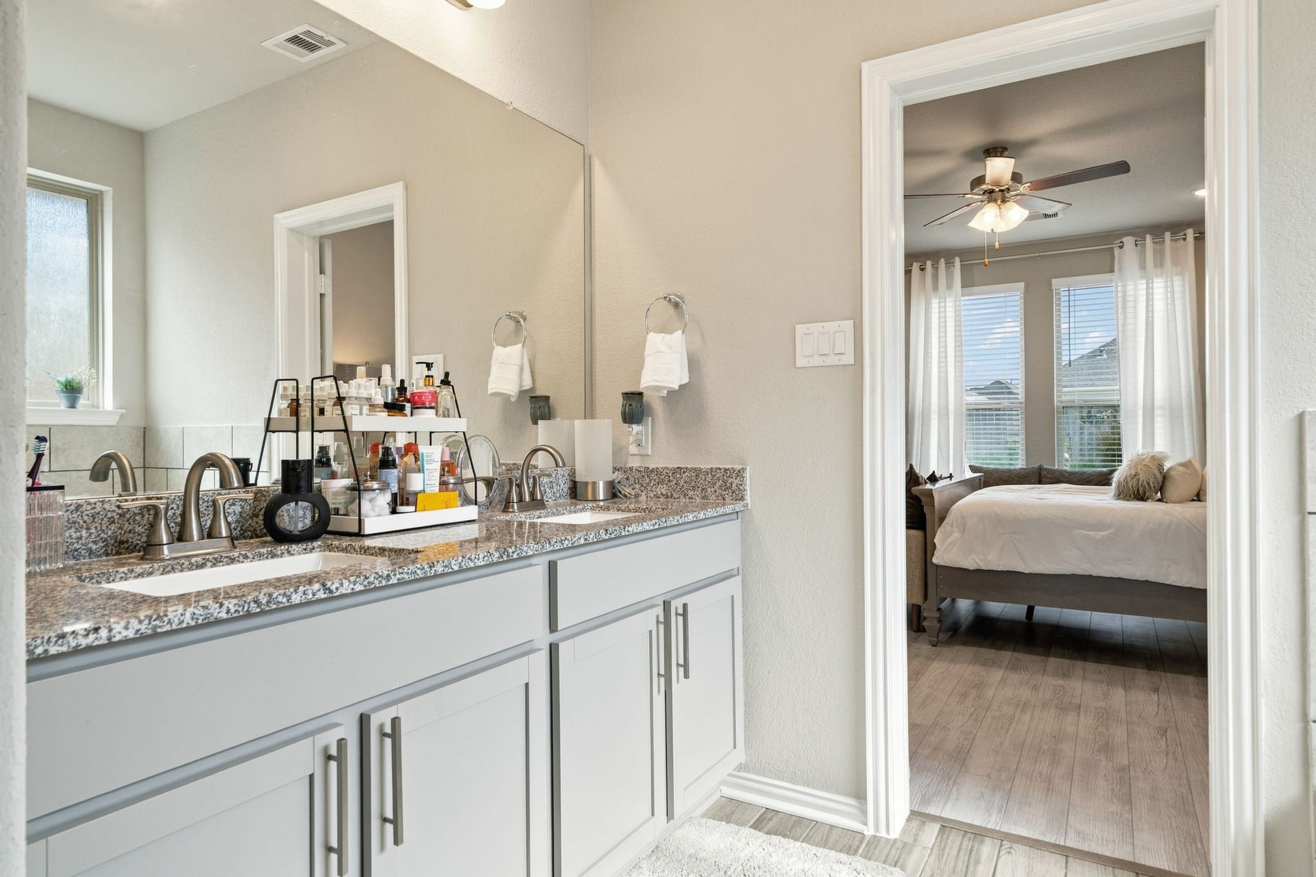 31410 Whitfield Court, Fulshear, TX 77441 Bright and inviting bathroom with a double vanity and modern fixtures, seamlessly connected to a cozy bedroom with ample natural light.
