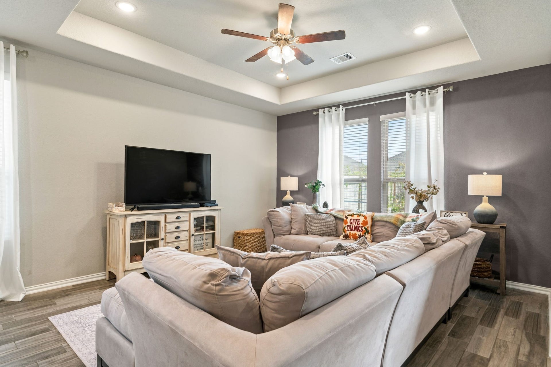 31410 Whitfield Court, Fulshear, TX 77441 Experience cozy living in this inviting family room, elegant tray ceiling, and abundant natural light.