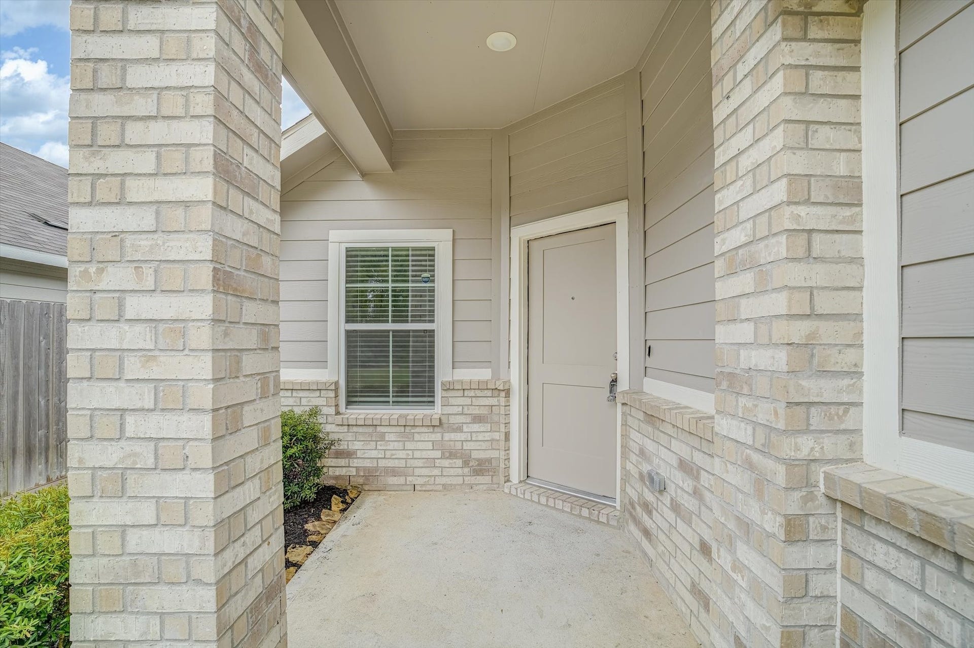 9607 Bright Song Lane, Houston, TX 77078 Inviting front porch with elegant brick detailing and a charming entryway, offering a warm welcome to your new home.
