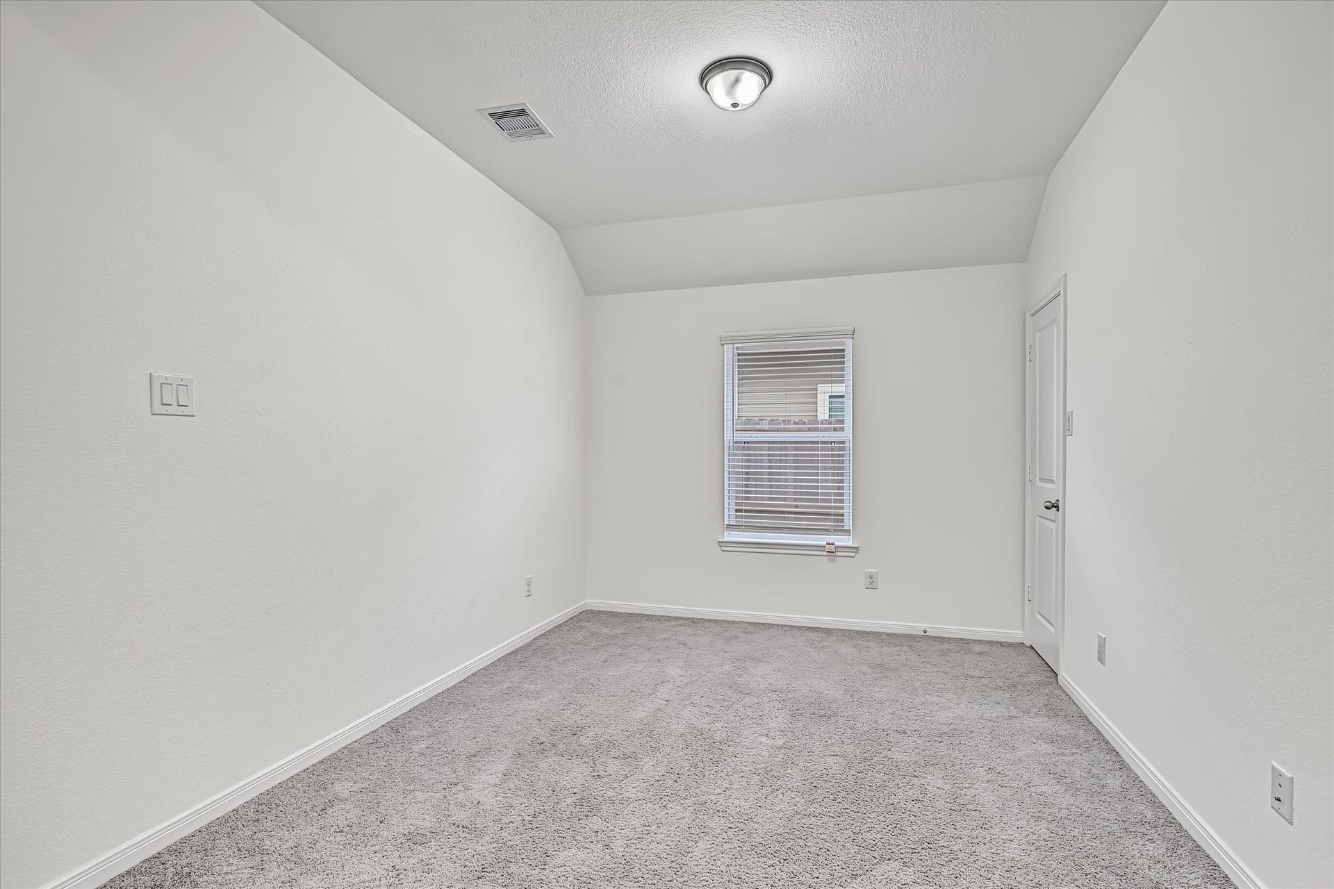 9607 Bright Song Lane, Houston, TX 77078 Cozy Game Room with soft carpeting, neutral walls, and a window allowing natural light to fill the space.