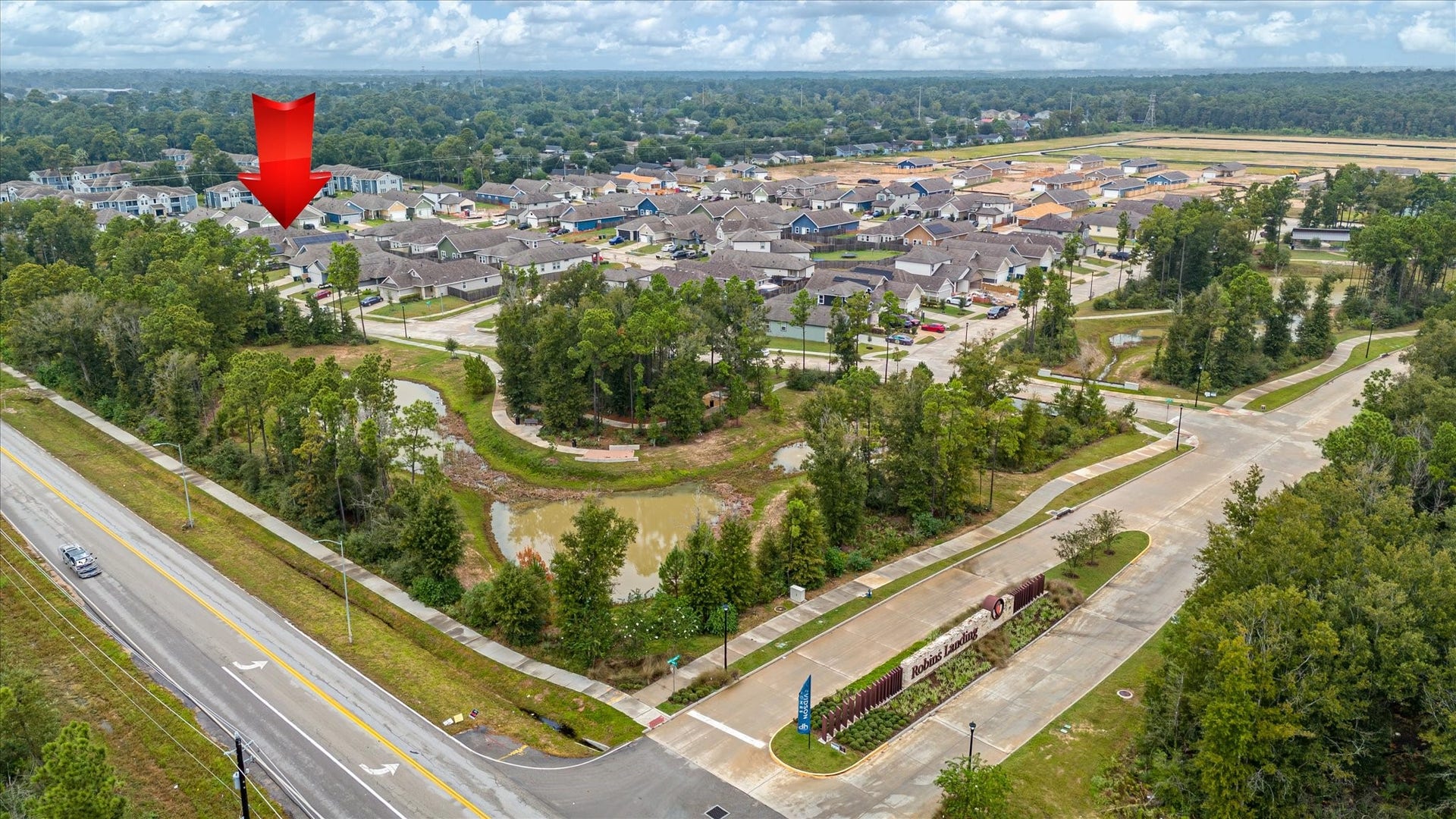 9607 Bright Song Lane, Houston, TX 77078 Charming neighborhood with modern homes surrounded by lush greenery and scenic ponds, offering a serene suburban setting with convenient road access.