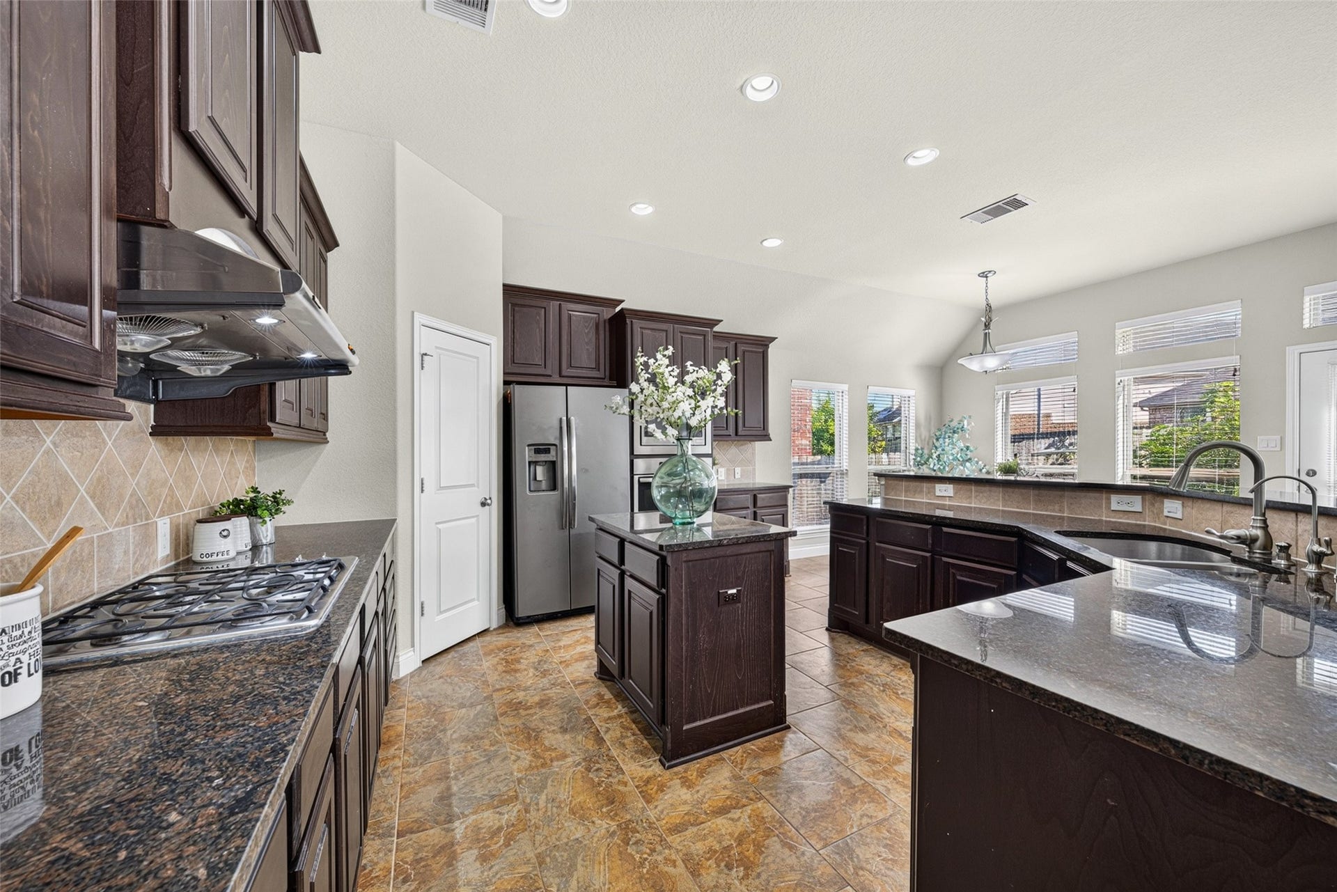 4003 Birch Vale Lane, Sugar Land, TX 77479 Gourmet kitchen featuring custom-built cabinetry, wide countertops, and sleek stainless steel appliances.