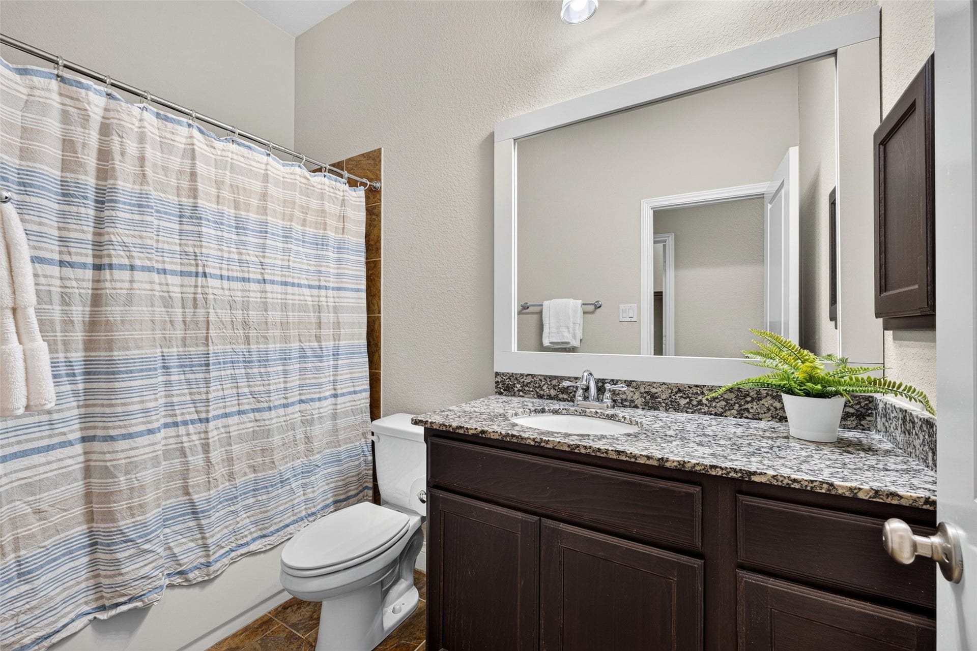 4003 Birch Vale Lane, Sugar Land, TX 77479 Clean and sparkling guest bathroom equipped with ample vanity storage and quality finishes.