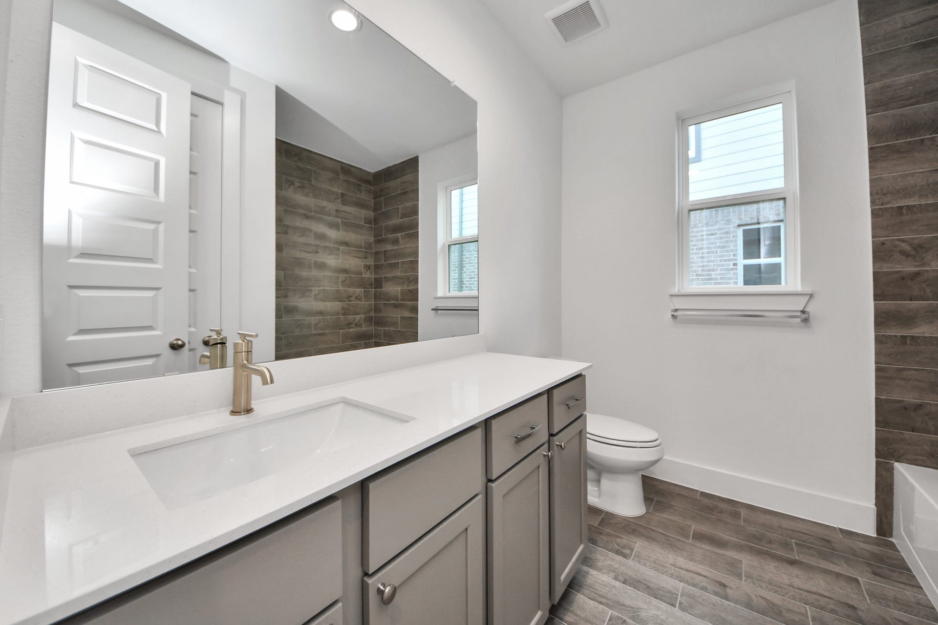 3201 Skerne Spring Drive, Spring, TX 77373 Secondary bath features tile flooring, bath/shower combo with tile surround, light stained wood cabinets, beautiful light countertop. Sample photo of completed home with similar floor plan. Actual colors and selections may vary.