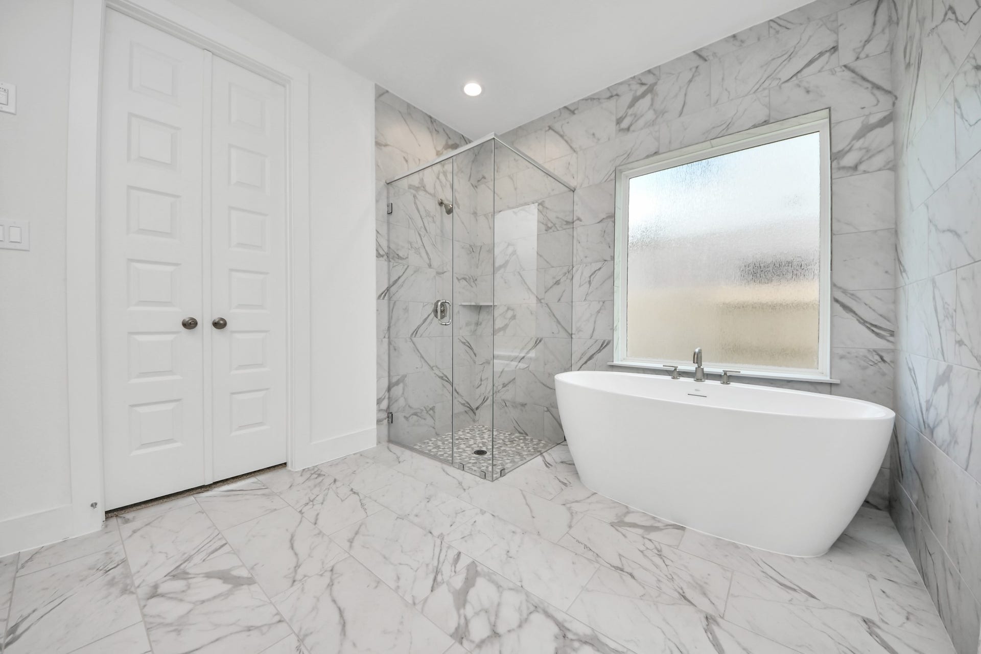 3201 Skerne Spring Drive, Spring, TX 77373 Indulge in a spa-like retreat within the confines of this primary bathroom. Delight in a spacious walk-in shower enveloped in stylish tile surround, unwind in a separate garden tub adorned with custom detailing. Sample photo of completed home with similar floor plan. Actual colors and selections may vary.