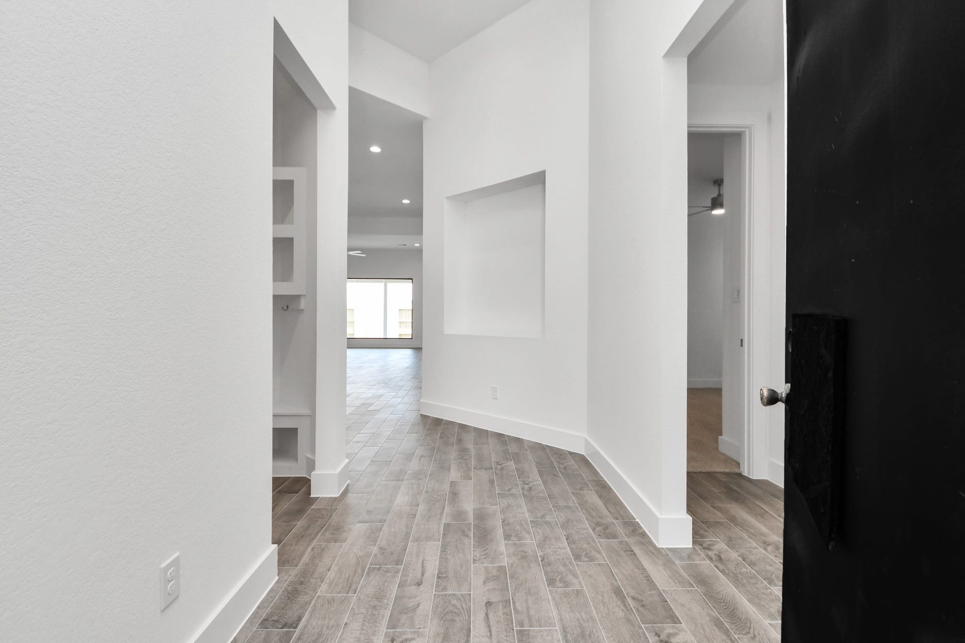 3201 Skerne Spring Drive, Spring, TX 77373 As you step into the threshold of this luxurious home, you'll soon be welcomed by an elegant glass door (to be installed). Inside, soaring ceilings amplify the spaciousness, while the refined wood-look tile flooring and oversized baseboards exude sophistication and charm. Sample photo of completed home with similar floor plan. Actual colors and selections may vary.