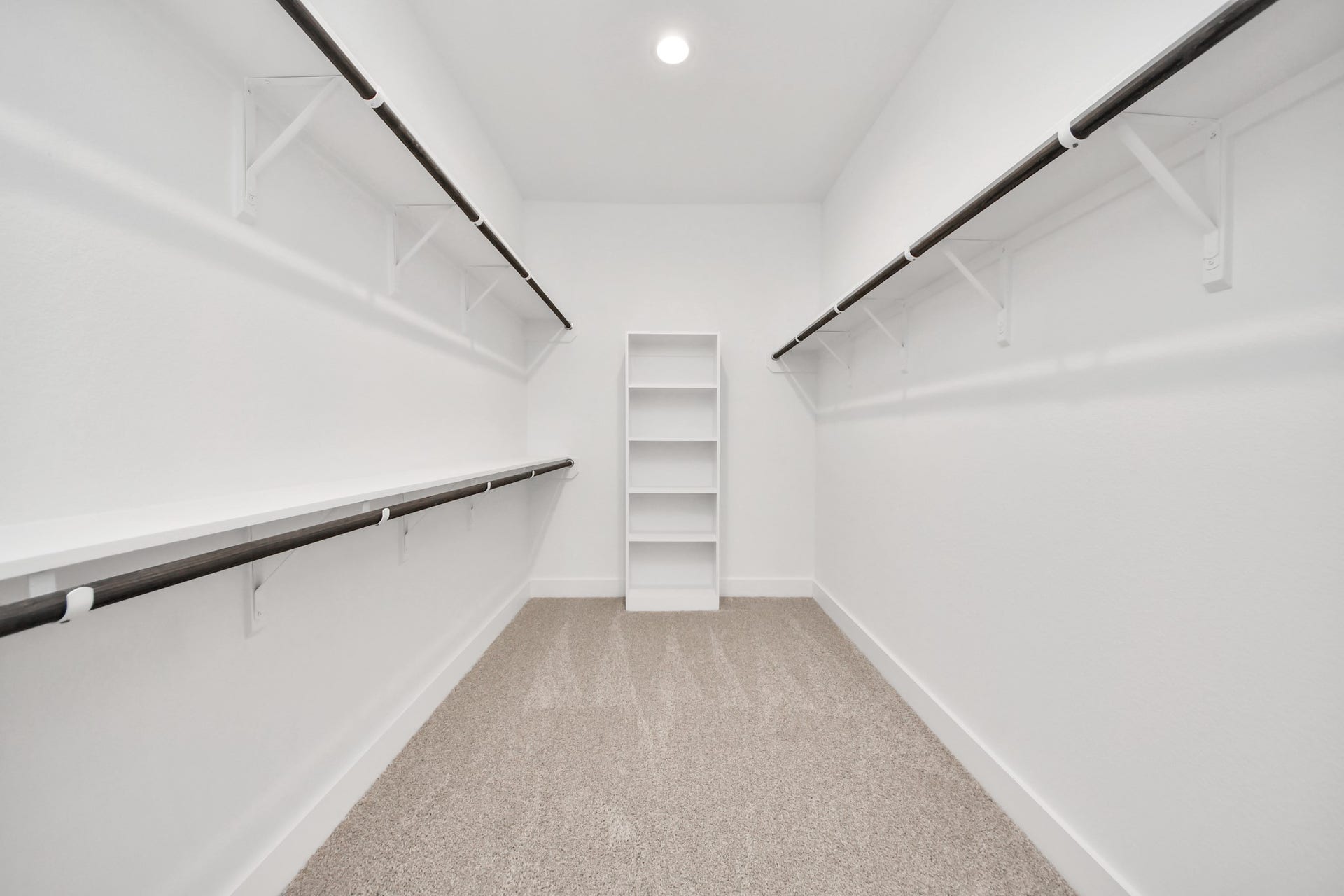 3201 Skerne Spring Drive, Spring, TX 77373 Walk-in closet that epitomizes luxury and practicality. This generously sized space features built-in shelving, offering abundant room for impeccable organization. High ceilings and recessed lighting create a bright and welcoming ambiance. Sample photo of completed home with similar floor plan. Actual colors and selections may vary.