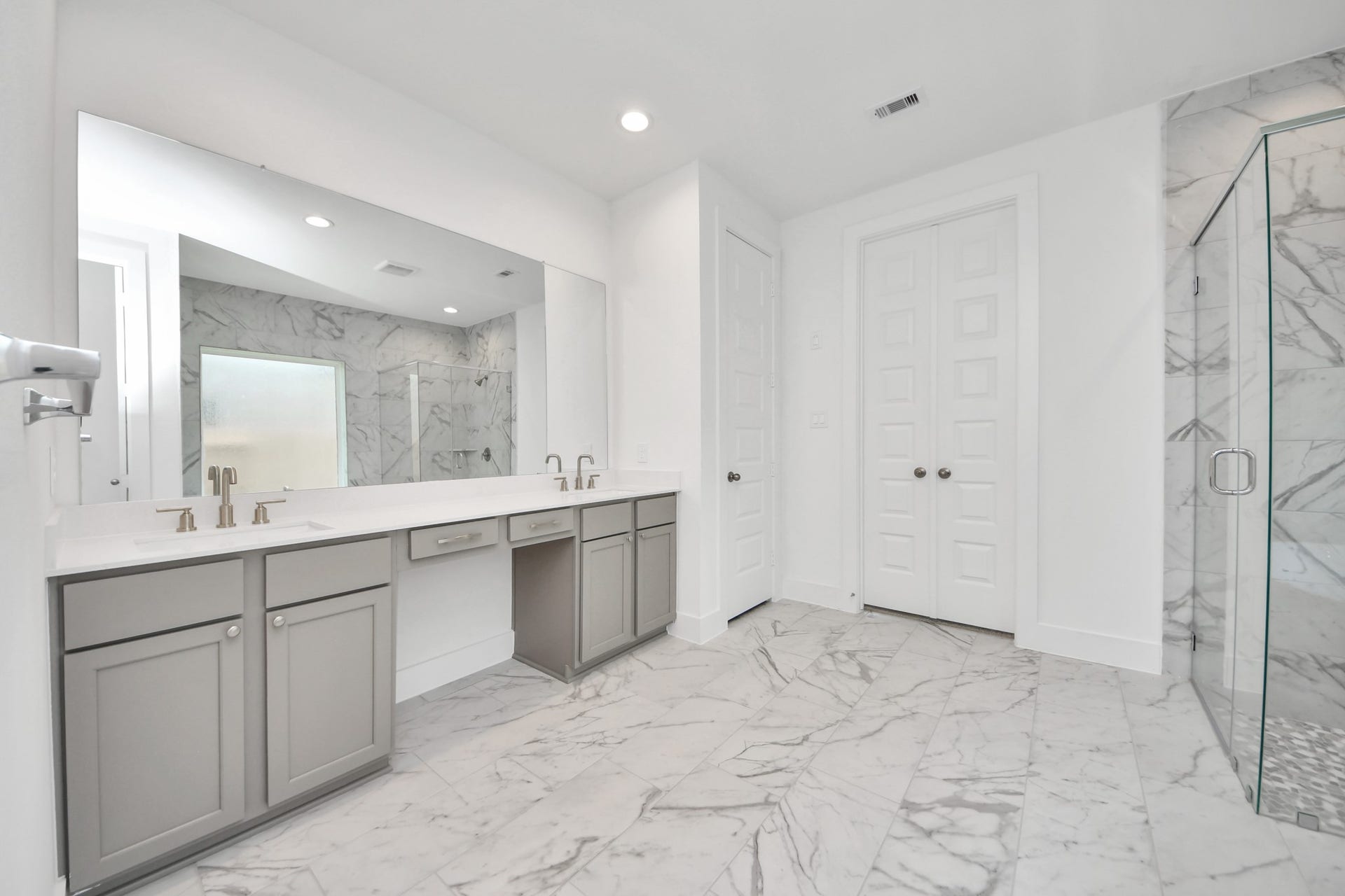 3201 Skerne Spring Drive, Spring, TX 77373 Elevate your daily routine at the elegant vanity, now equipped with double sinks, light countertops, modern hardware, and beautiful recessed lights. Sample photo of completed home with similar floor plan. Actual colors and selections may vary.