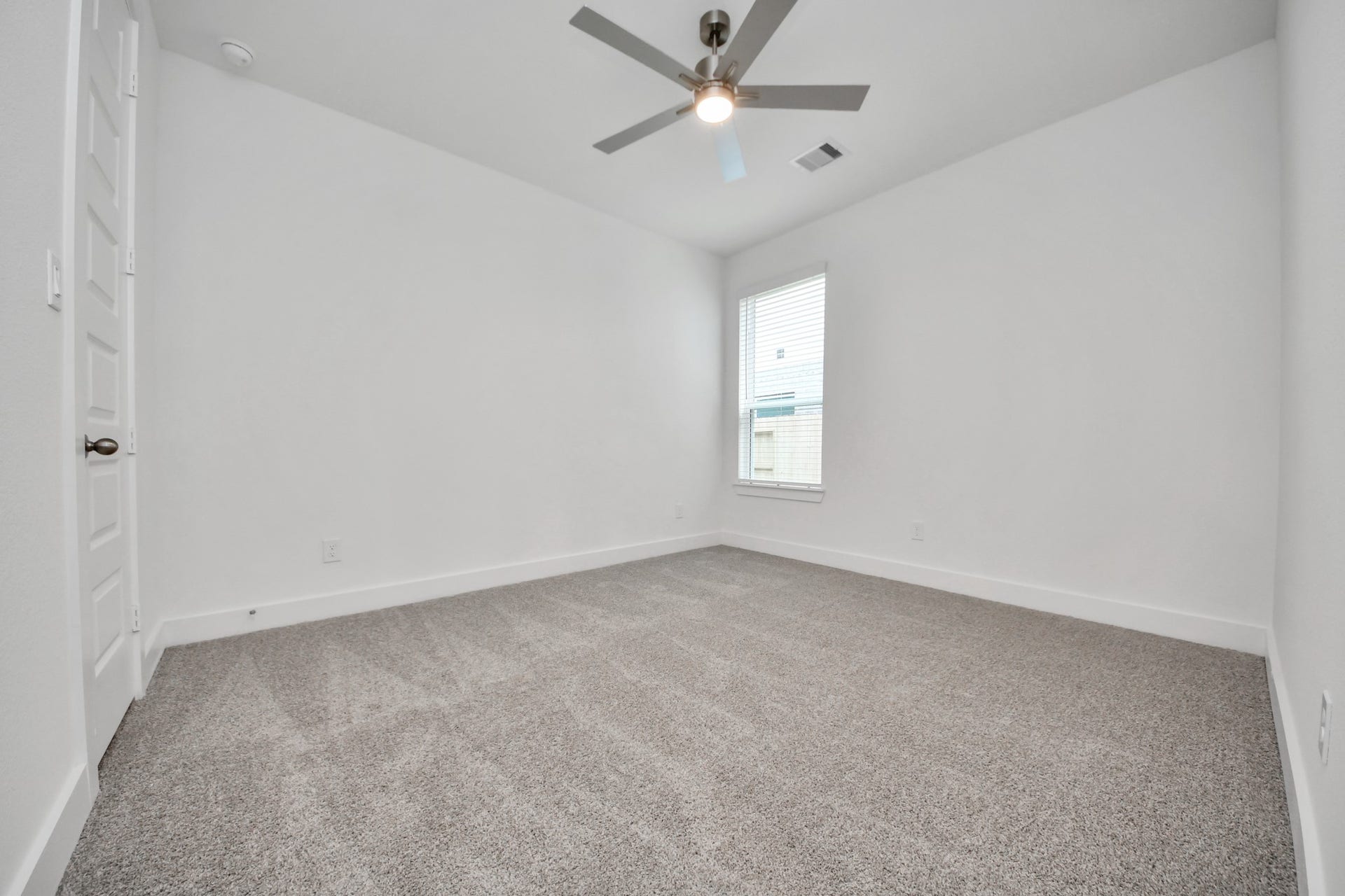 3201 Skerne Spring Drive, Spring, TX 77373 Secondary bedroom features plush carpeting, large windows that let in plenty of natural light, bright paint, and spacious closets. Sample photo of completed home with similar floor plan. Actual colors and selections may vary.