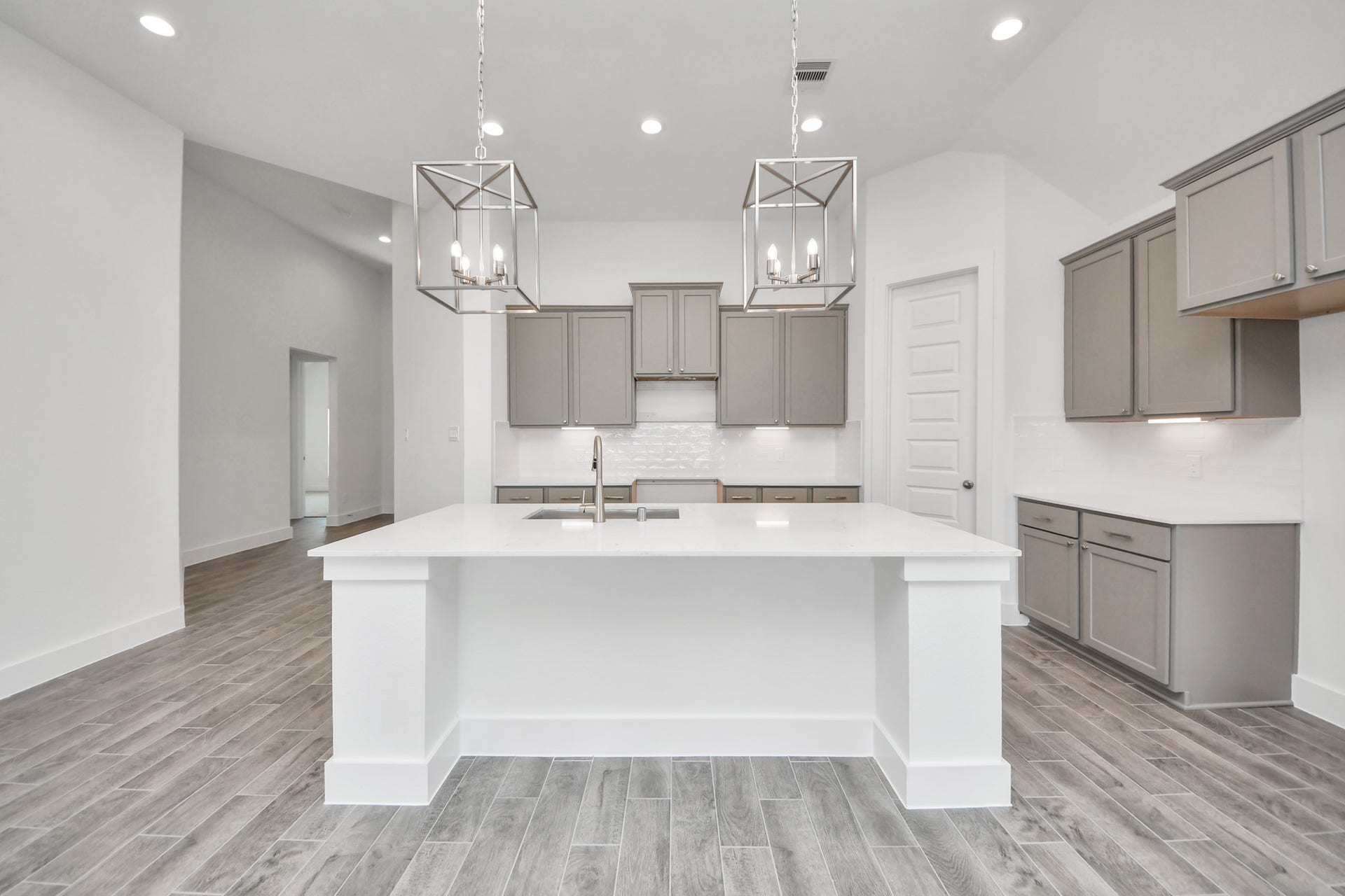 3201 Skerne Spring Drive, Spring, TX 77373 This kitchen is by far any chefs dream! This spacious kitchen features high ceilings, light stained wood cabinets, granite countertop, SS appliances, modern tile backsplash, recessed lighting, extended counter space, granite kitchen island, and space for breakfast bar, and a walk-in pantry all overlooking your huge family room. Sample photo of completed home with similar floor plan. Actual colors and selections may vary.