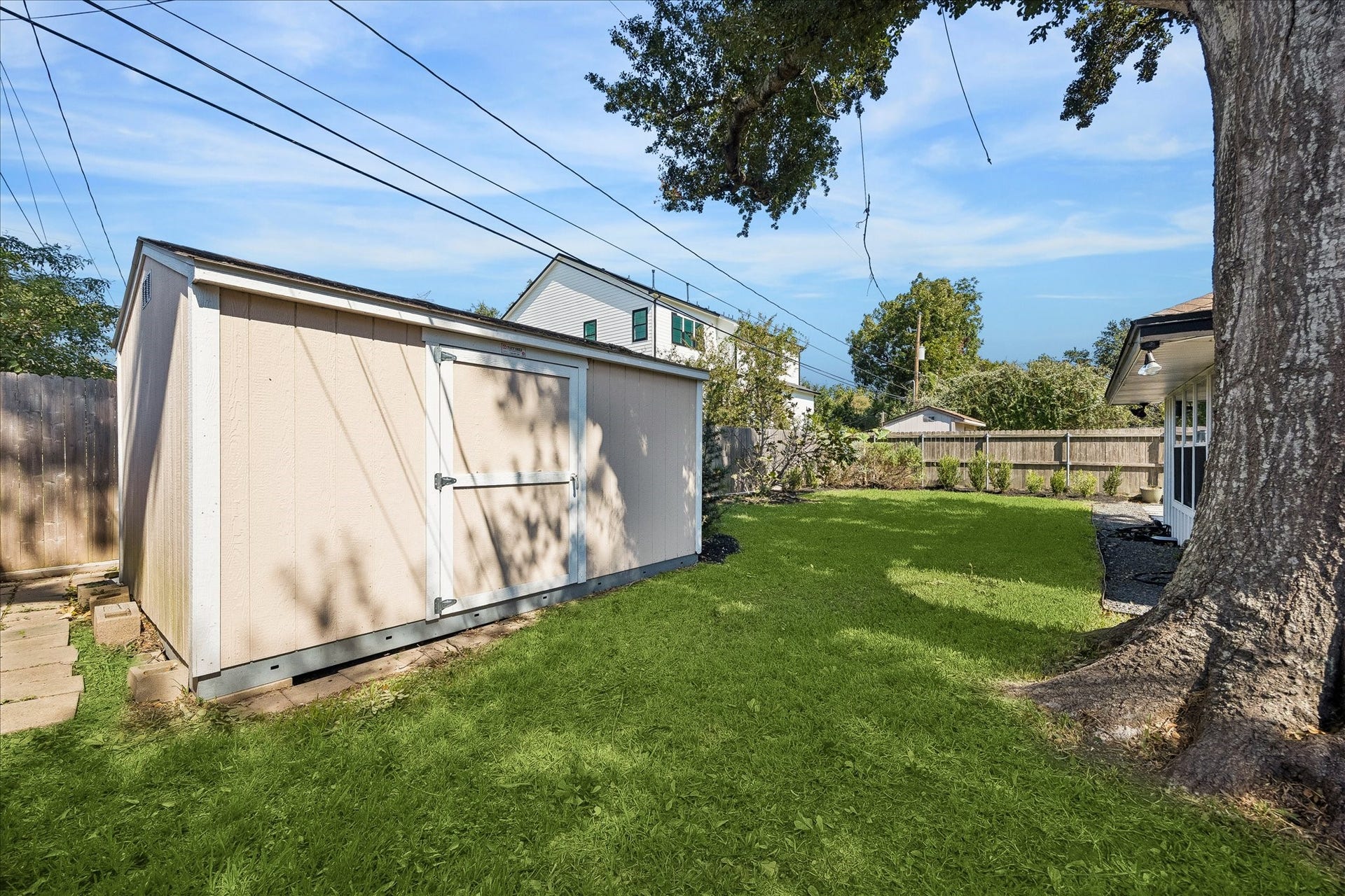 2214 Bron Holly Drive, Houston, TX 77018 Expansive lawn, established greenery, and beautiful shade create a peaceful outdoor escape.
