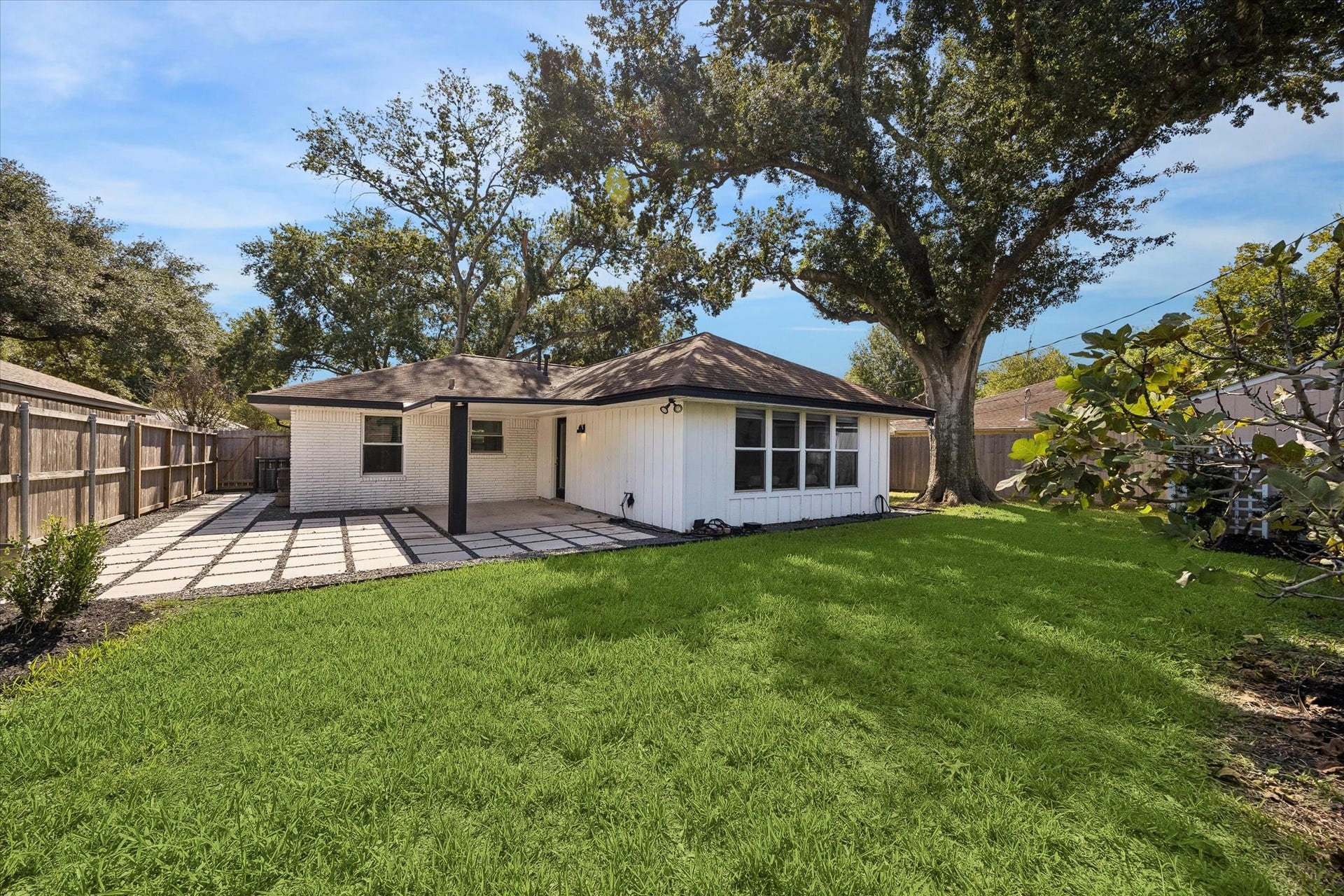 2214 Bron Holly Drive, Houston, TX 77018 A generous backyard with lush green space, mature trees, and room to enjoy the outdoors.