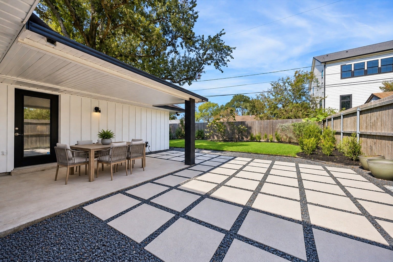 2214 Bron Holly Drive, Houston, TX 77018 Contemporary concrete pavers and a covered patio set the stage for effortless outdoor entertaining. This photo has been virtually staged with outdoor furniture.