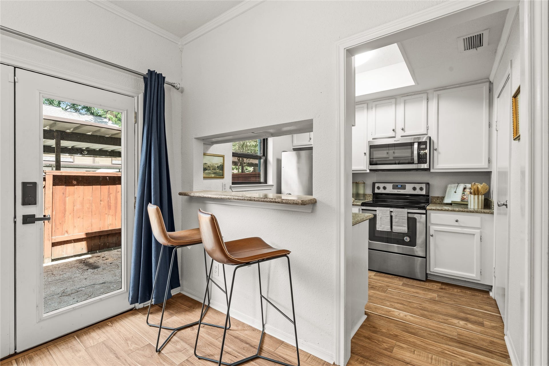 11711 Memorial Drive, #593, Houston, TX 77024 Extra seating at the breakfast bar adds everyday functionality while keeping the kitchen open to the dining area.