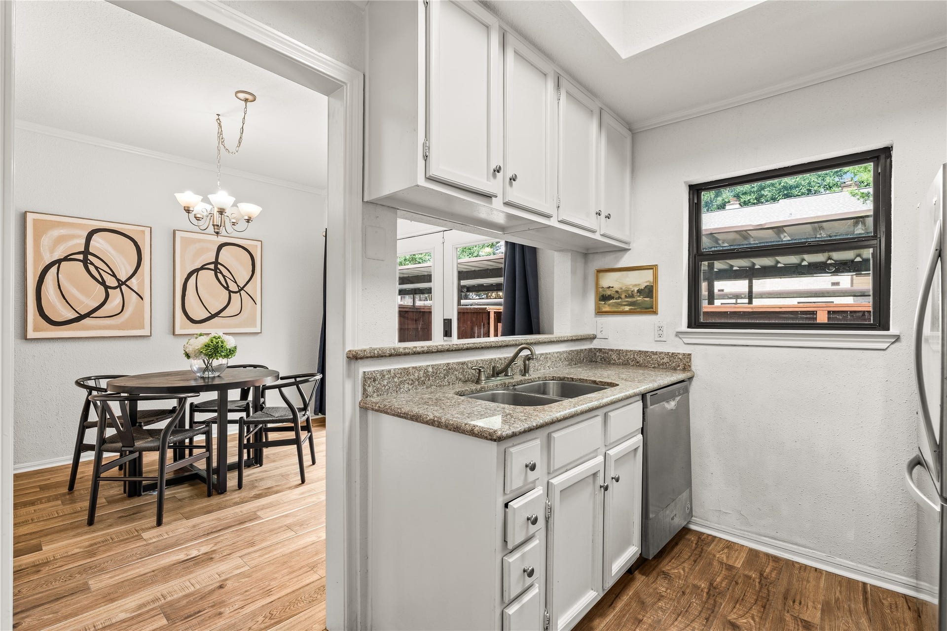 11711 Memorial Drive, #593, Houston, TX 77024 A functional kitchen with abundant upper cabinetry, stainless steel appliances, and an open pass-through that keeps the space feeling bright and connected.