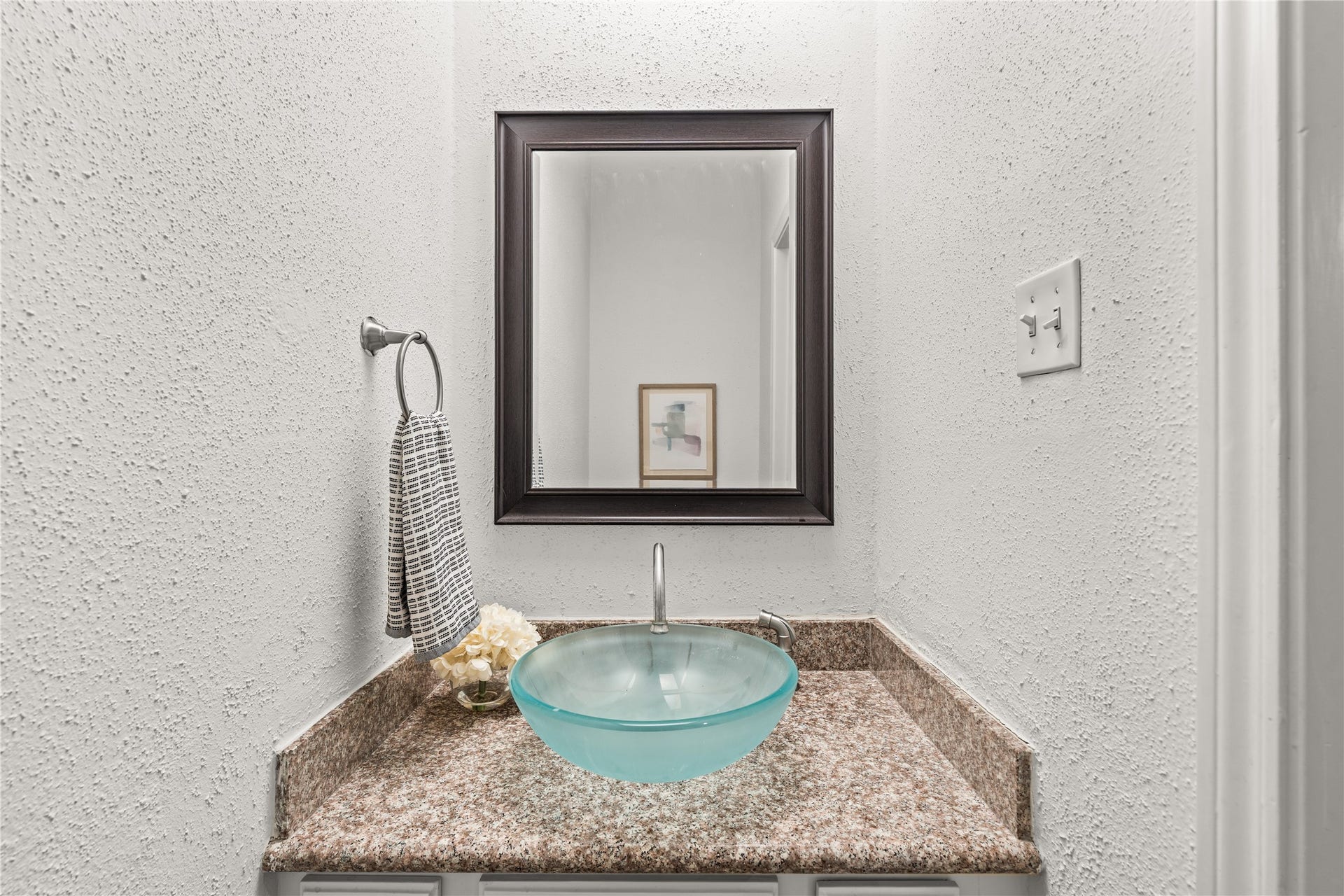 11711 Memorial Drive, #593, Houston, TX 77024 Thoughtfully positioned for guests, the powder bath adds everyday convenience to the main living level.