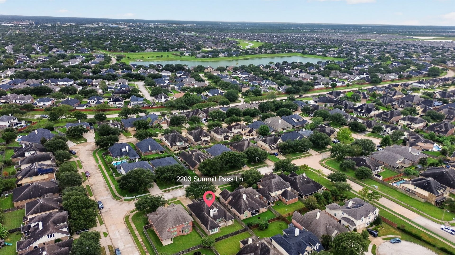 2203 Summit Pass Lane, League City, TX 77573 Aerial View of the home and nearby lake.