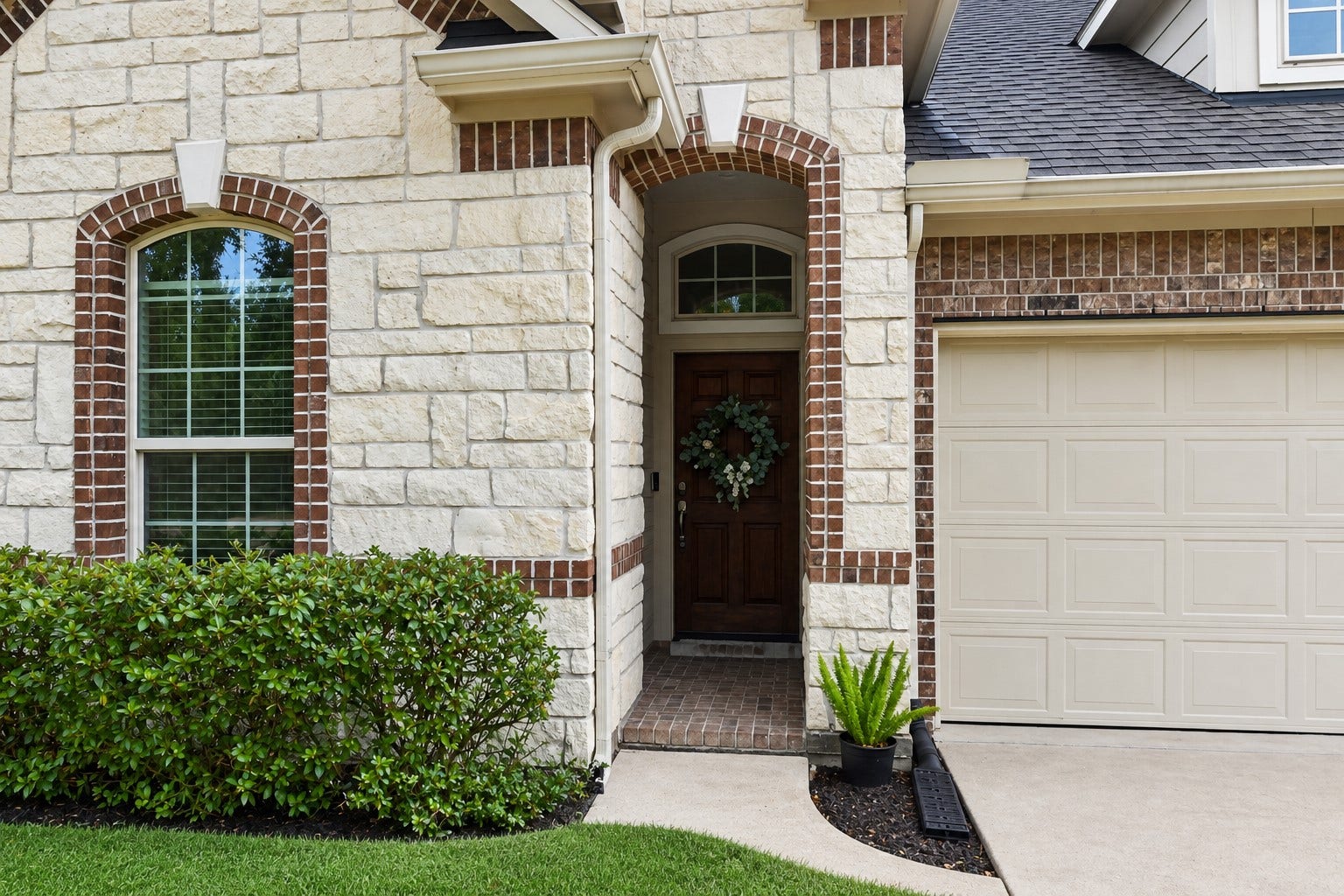 2203 Summit Pass Lane, League City, TX 77573 Stone and brick elevation with a welcoming covered arched entry.
