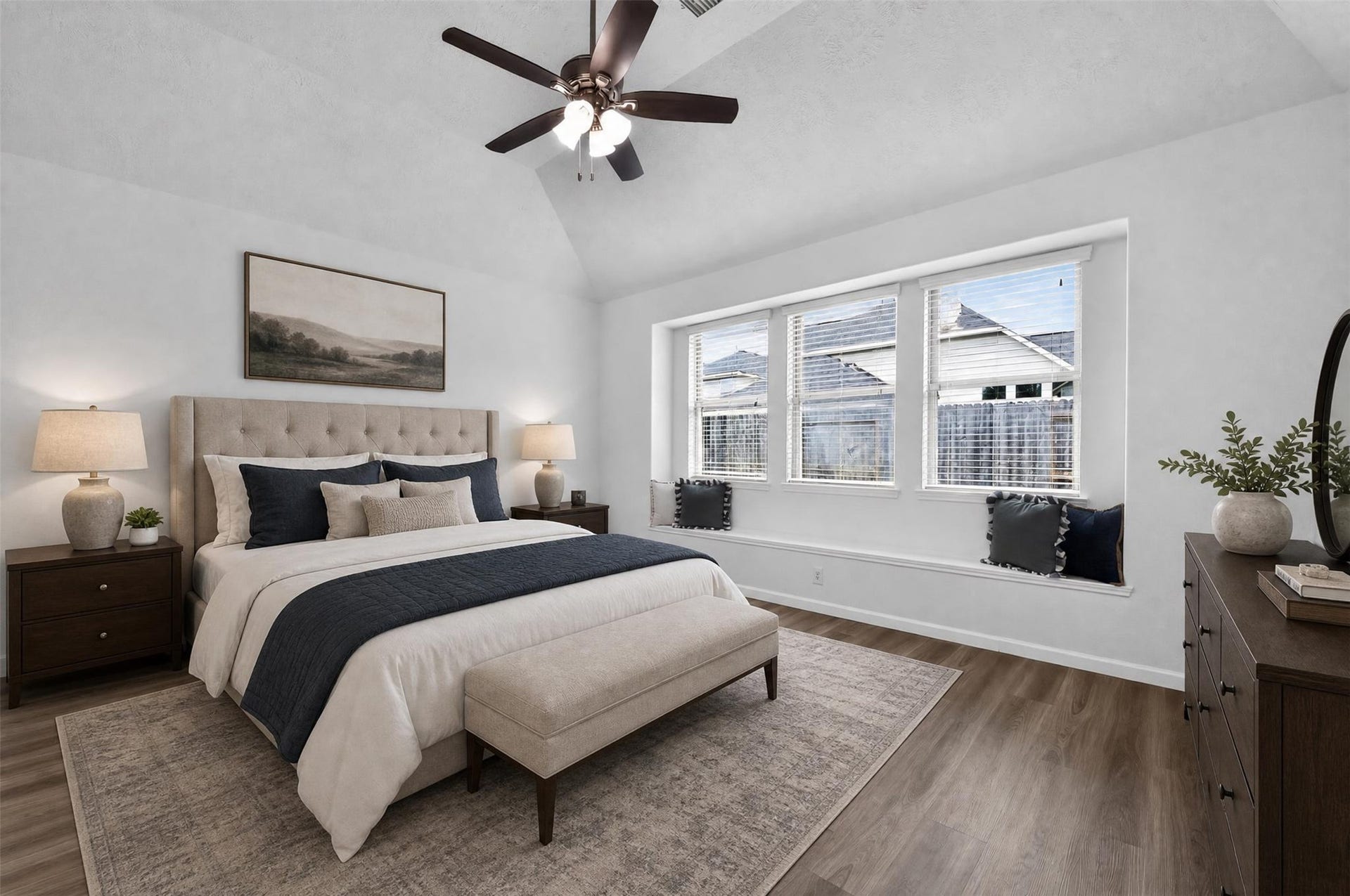 The primary bedroom with impressive wall of windows with charming window seat! [*Photo has been virtually staged to offer design and layout ideas.]
