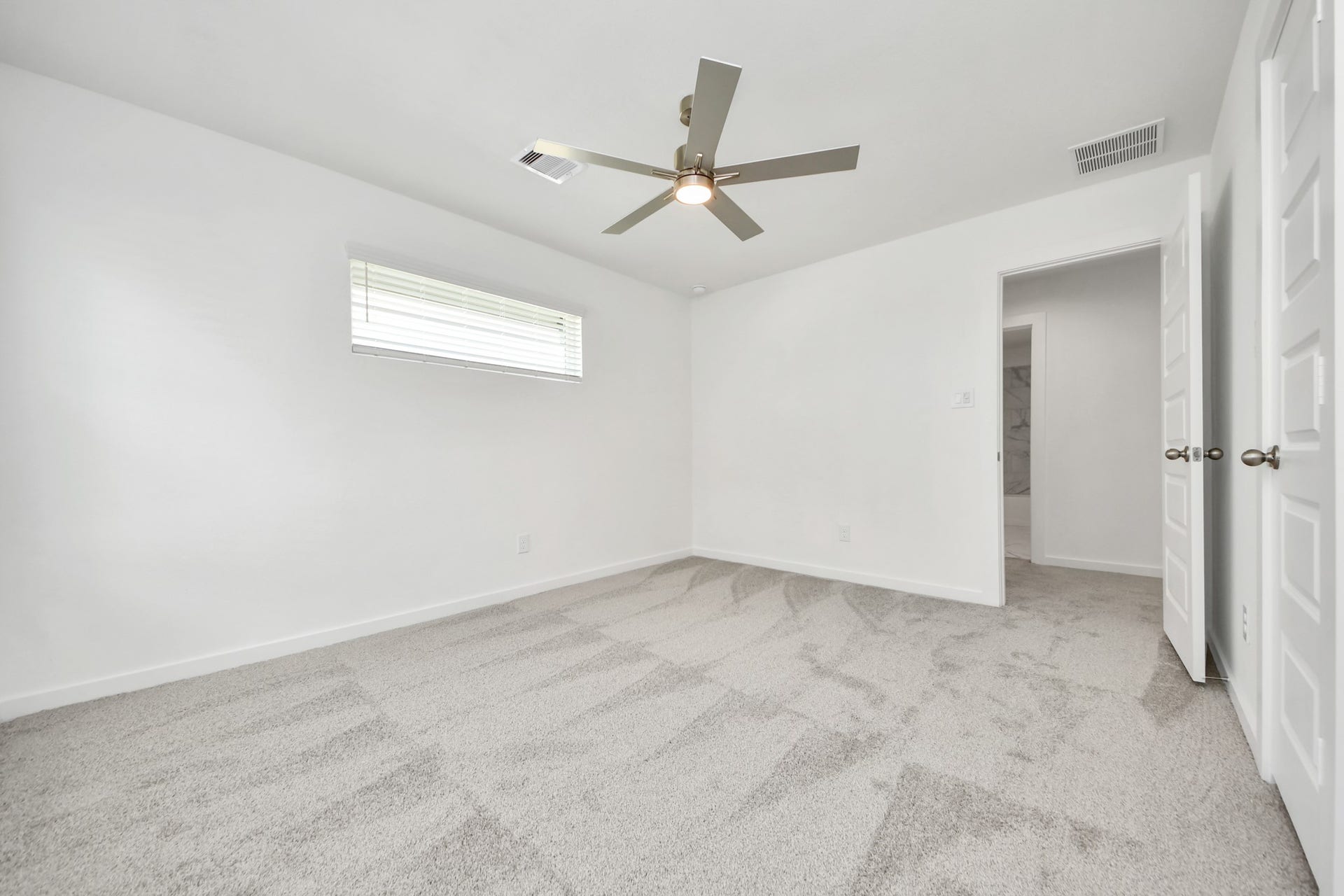 Generously sized secondary bedrooms featuring spacious closets, soft and inviting carpeting underfoot, large windows allowing plenty of natural light, and the added touch of privacy blinds for your personal retreat. Sample photo of completed home with similar floor plan. Actual colors and selections may vary.