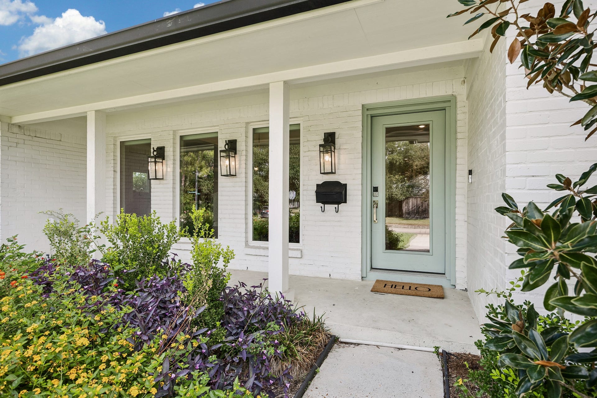 2503 Stoney Brook Drive, Houston, TX 77063 A charming covered front porch welcomes you home, complemented by beautiful landscaping and a soft green front door. Classic exterior details create an inviting first impression.