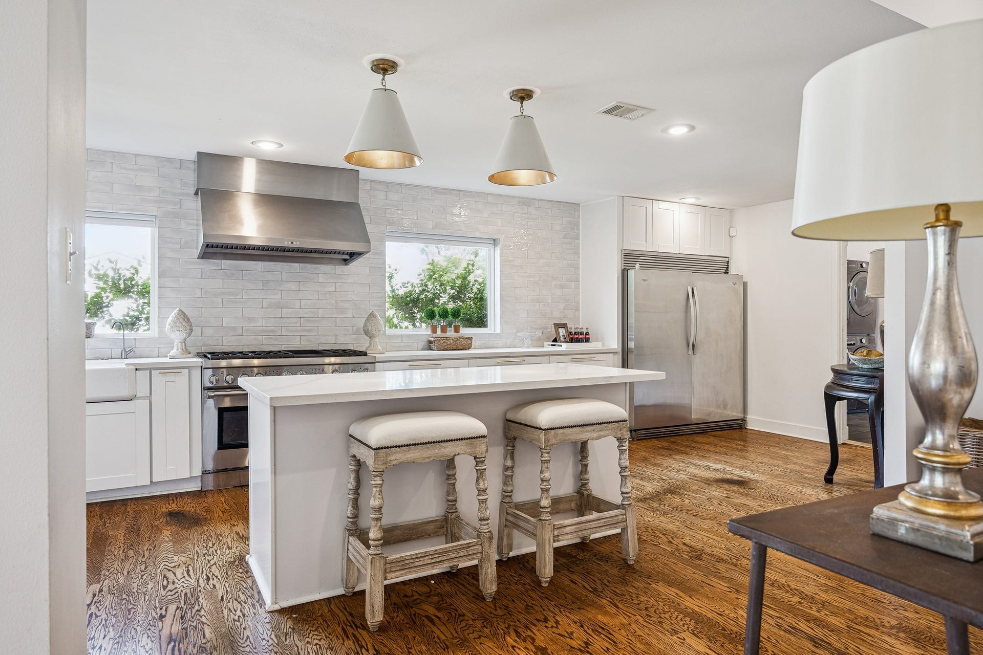 2503 Stoney Brook Drive, Houston, TX 77063 (25x10) This luxurious kitchen includes an apron sink, subway tile backsplash, Whirlpool side by side refrigerator, and an island that adds valuable prep space. Together, they create a layout as functional as it is refined.