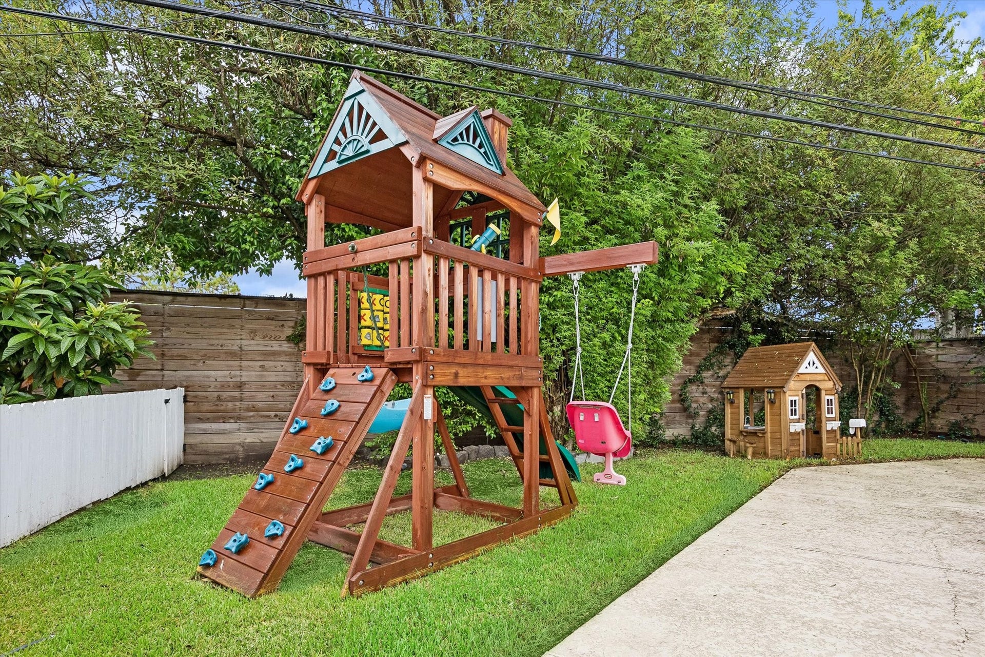 2503 Stoney Brook Drive, Houston, TX 77063 A private play area sits just beyond the pool's
safety fencing, offering peace of mind alongside
outdoor enjoyment. The thoughtfully zoned
backyard accommodates both relaxation and
recreation. Play set and doll house included with
the listing.