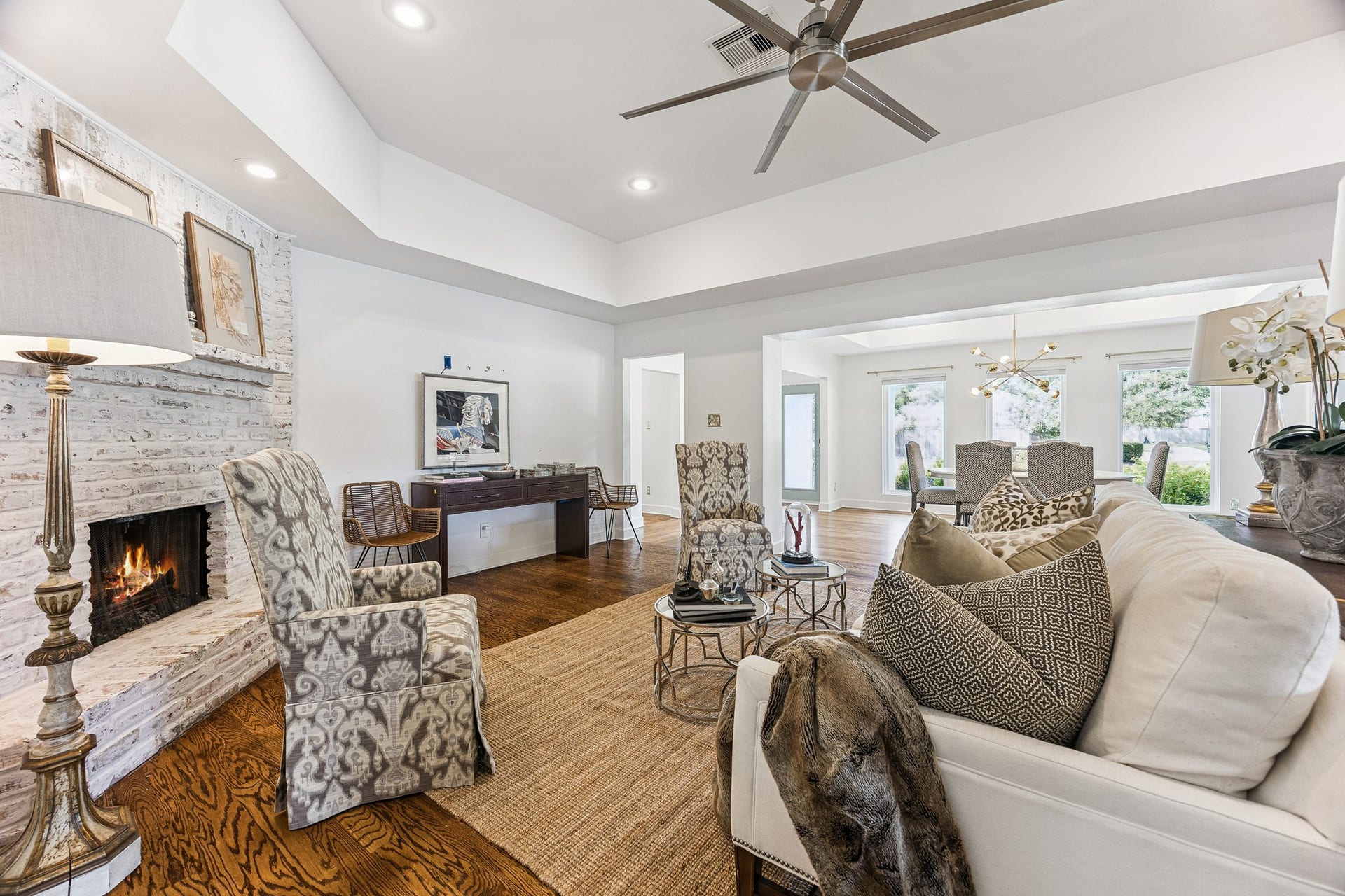 2503 Stoney Brook Drive, Houston, TX 77063 (20x16) There is nothing better than coming home to a crisp white painted home. The living room is grounded by a striking whitewashed brick fireplace, a natural focal point for the space. The open-concept design allows the dining and living rooms to connect seamlessly, ideal for both everyday living and entertaining. (Living Room television mount excluded)