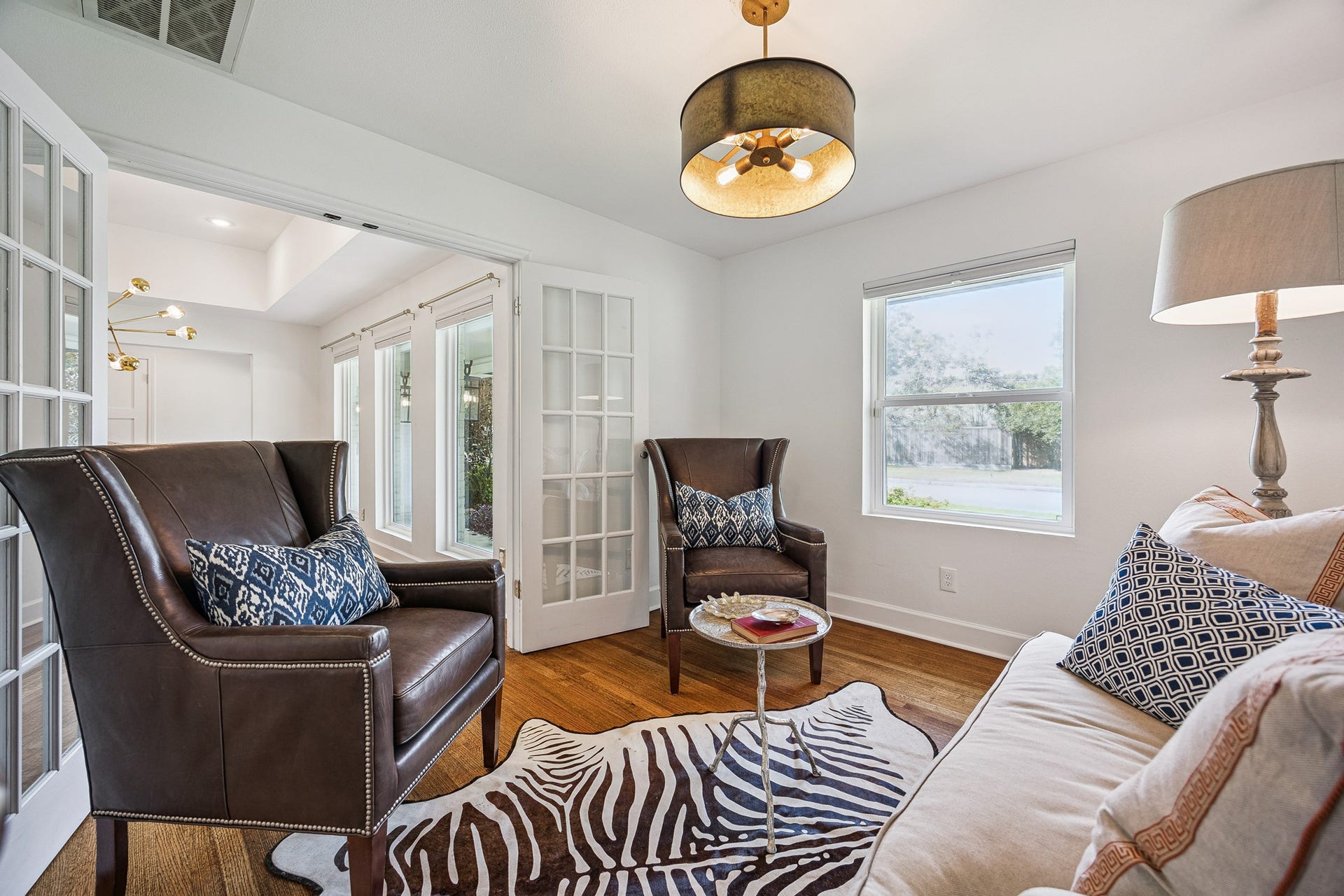 2503 Stoney Brook Drive, Houston, TX 77063 Tucked just off the dining room, this intimate sitting area offers flexibility to suit your lifestyle. A large window brings in natural light while French doors provide separation from the main living areas.