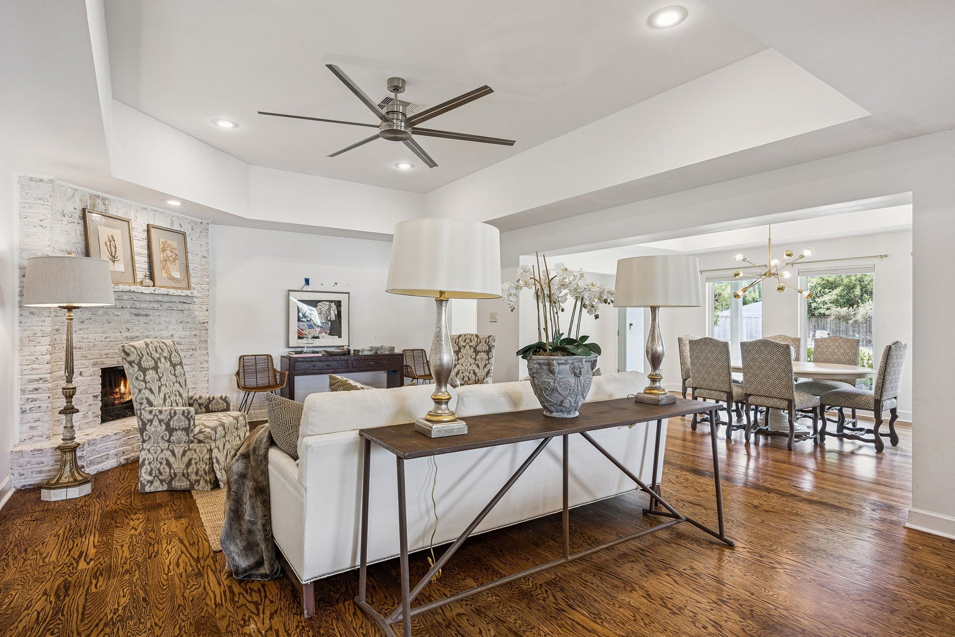 2503 Stoney Brook Drive, Houston, TX 77063 This expansive view highlights the home's seamless connection between the living and dining spaces. Hardwood floors and an open floor plan create a cohesive, welcoming environment.