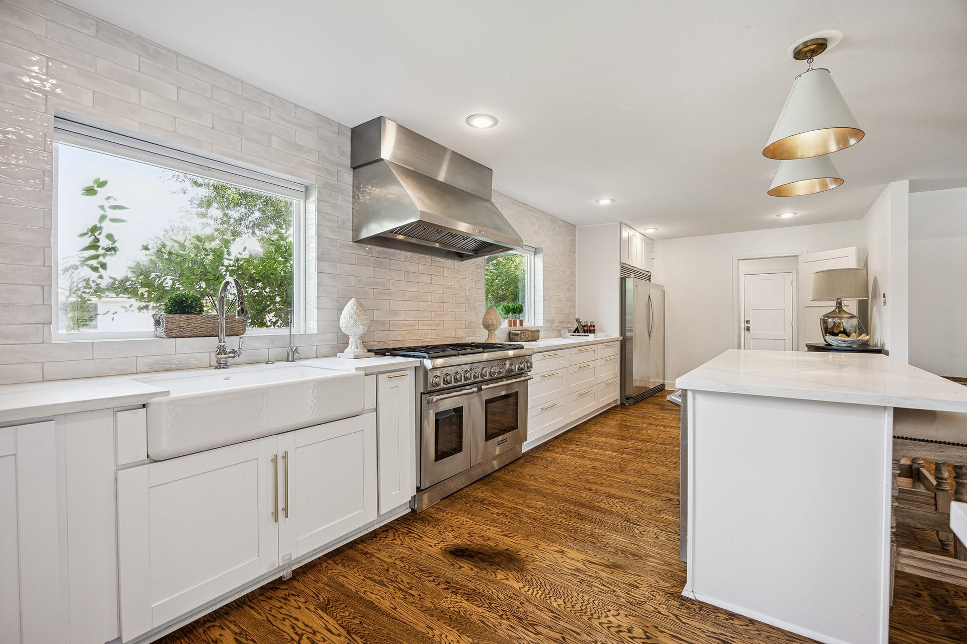 2503 Stoney Brook Drive, Houston, TX 77063 (25x10) The kitchen island opens directly into the living room, underscoring the home's effortless indoor flow. This connectivity makes the space equally suited to quiet mornings and lively gatherings.