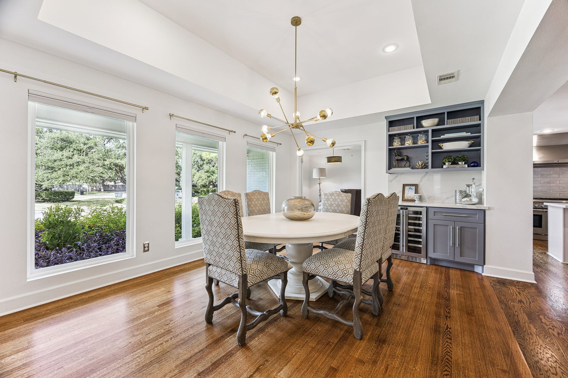 2503 Stoney Brook Drive, Houston, TX 77063 Enjoy views of the lush front landscaping through oversized windows in this light-filled dining space. A built-in beverage station with a wine refrigerator adds convenience when entertaining.