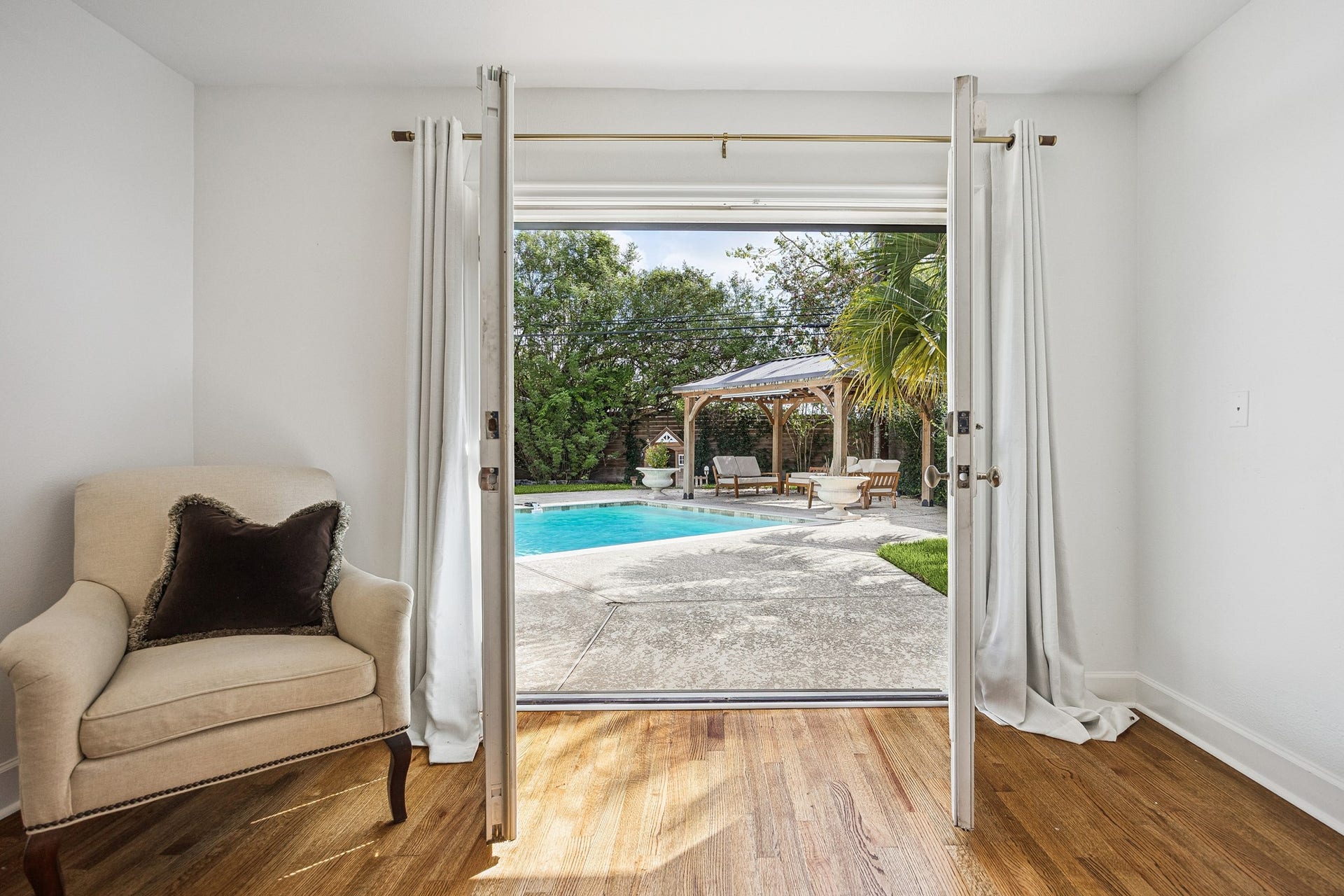 2503 Stoney Brook Drive, Houston, TX 77063 Enjoy convenient access to your private backyard oasis directly from the primary suite. French doors open toward the sparkling pool and covered outdoor pavilion.