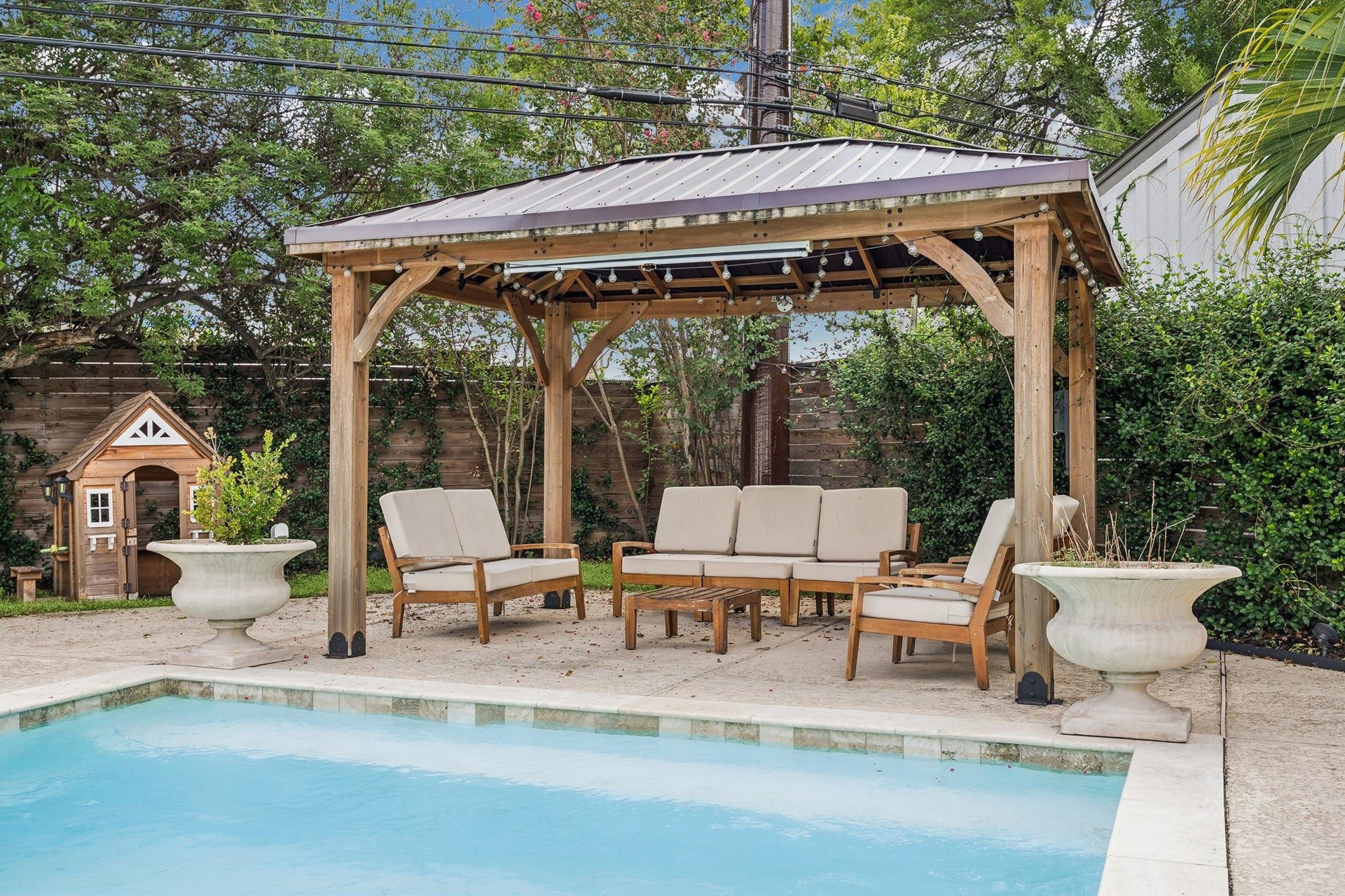 2503 Stoney Brook Drive, Houston, TX 77063 This pergola seating area enjoys sweeping views of the pool beyond, creating a seamless connection between shaded lounging and outdoor recreation.
The space is designed for effortless indoor-outdoor entertaining.