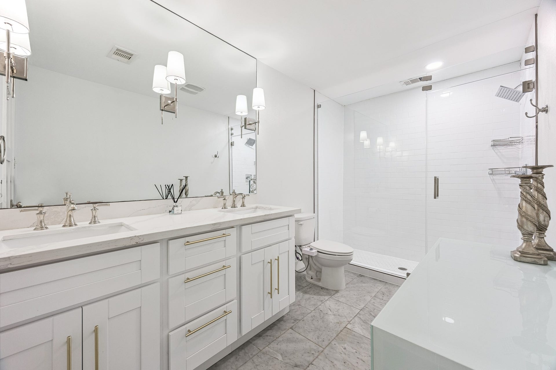 2503 Stoney Brook Drive, Houston, TX 77063 This spa-inspired bath features dual vanities paired with a frameless glass shower, offering both function and refined style. Clean lines and quality finishes come together for an elevated everyday routine.