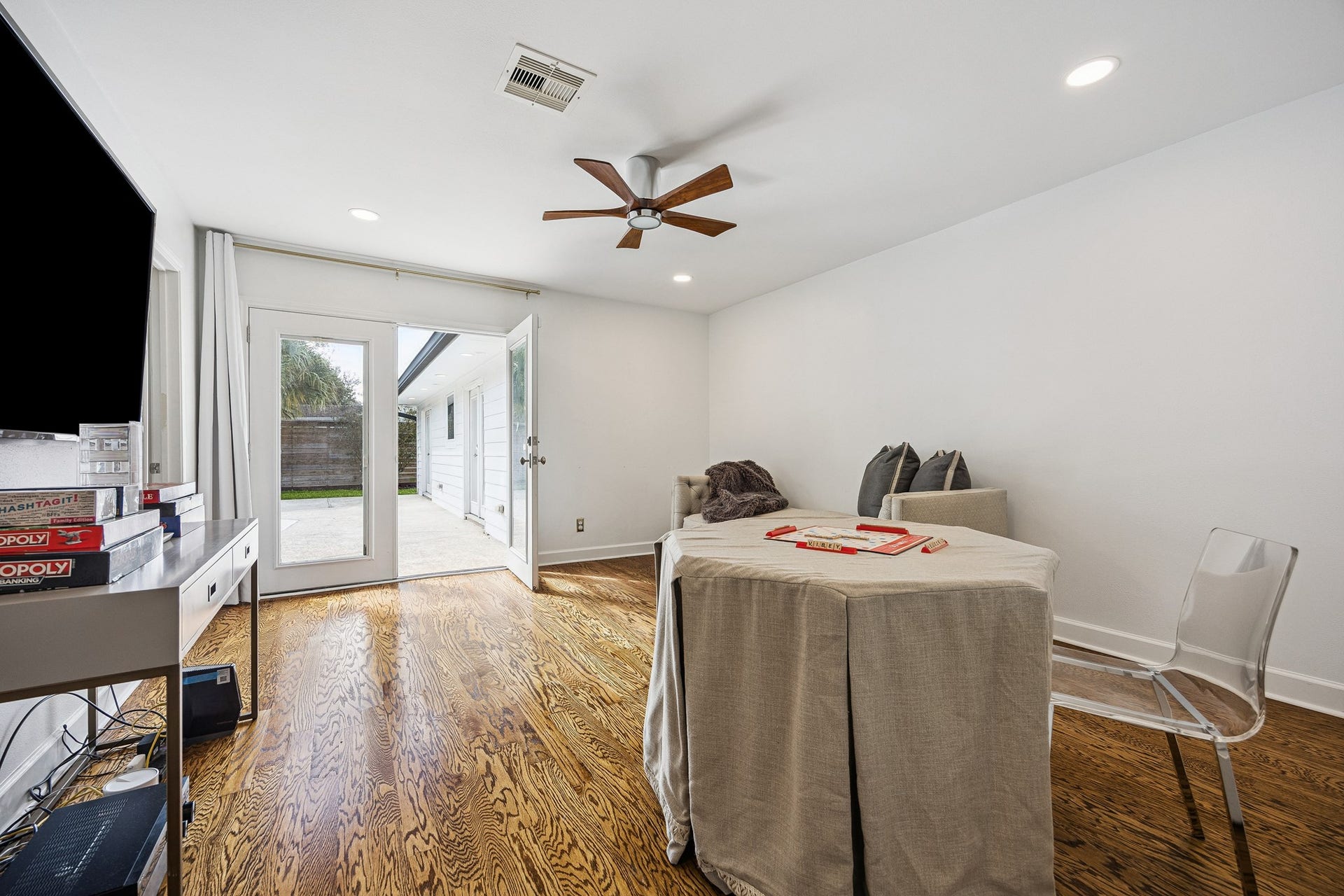 2503 Stoney Brook Drive, Houston, TX 77063 (22x9) French doors provide direct outdoor access from this guest bedroom, showcasing indoor-outdoor living at its finest. The result is a light-filled, tranquil space with effortless connectivity.